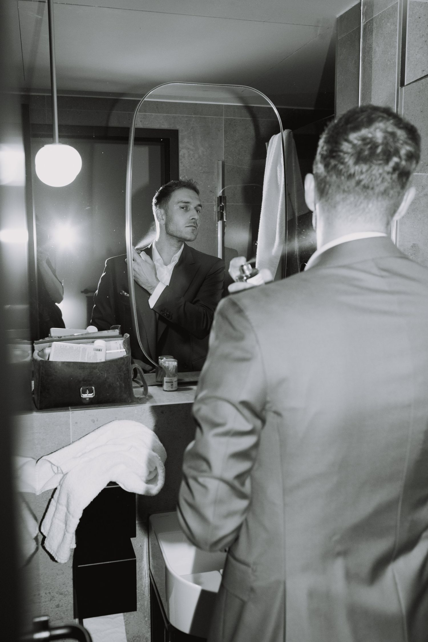 Black and white photo of a dressing room mirror reflection with vintage lighting.