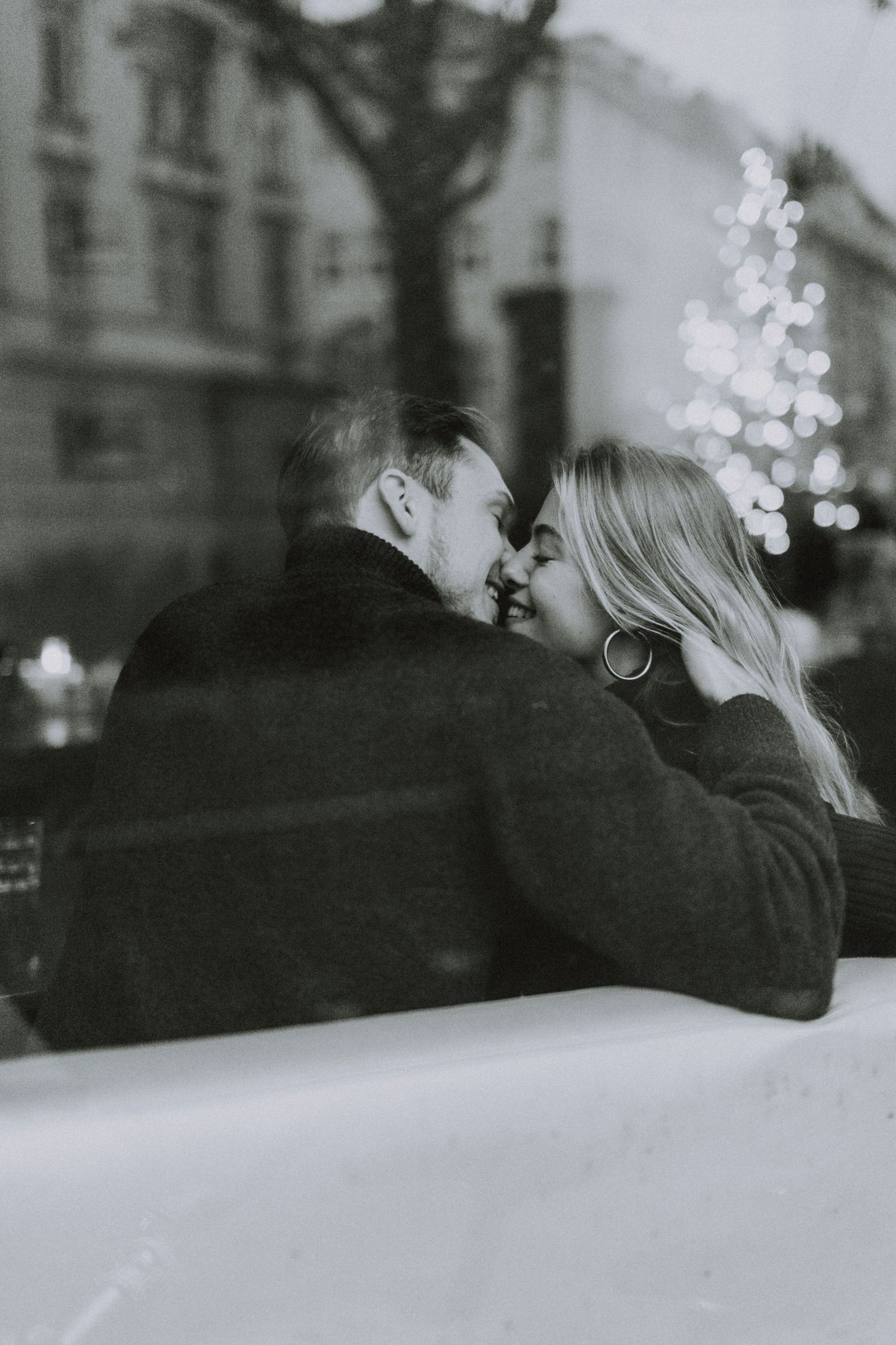 Black and white artistic series of romantic moments in soft focus with bokeh lights.