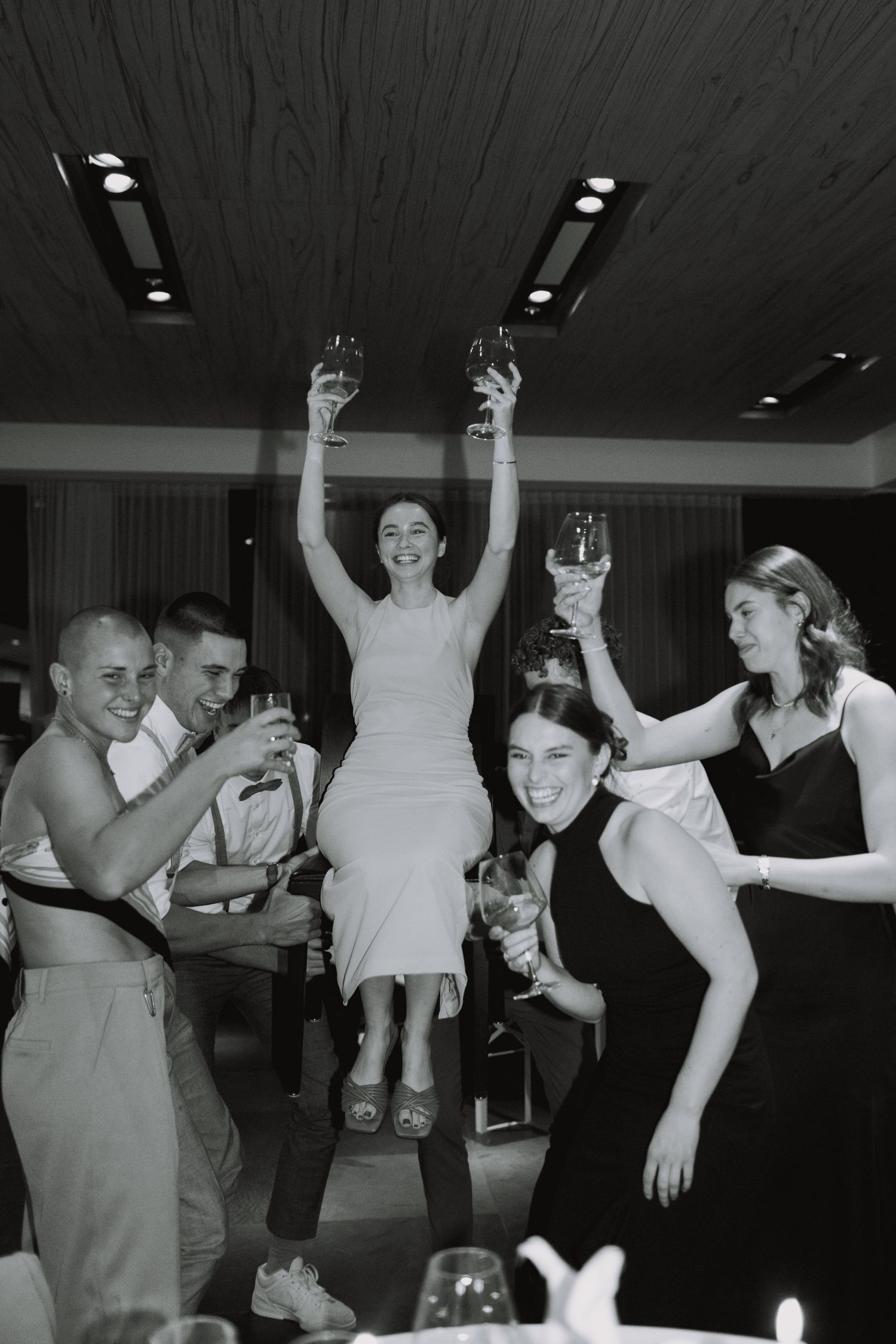 Wedding reception dance party captured in black and white photography.