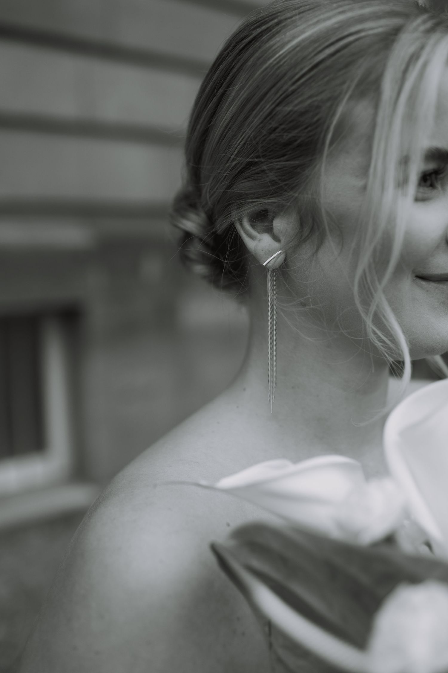 Close-up profile shot showing elegant bridal jewelry and hairstyle.