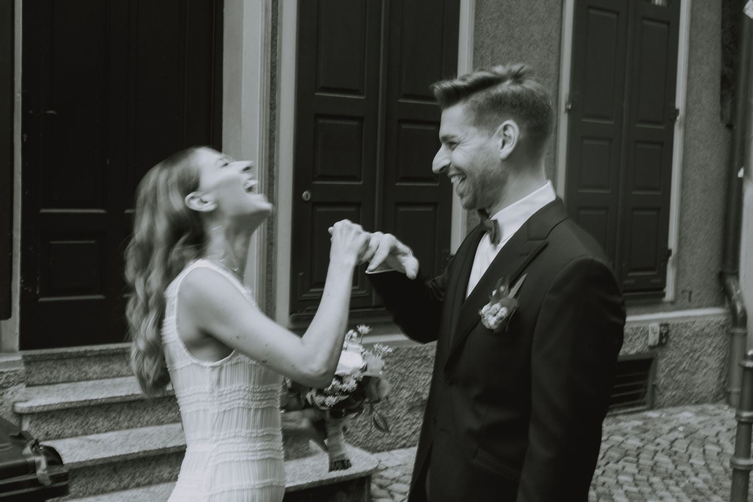 A bride and groom dance together during their wedding celebration in an elegant venue.