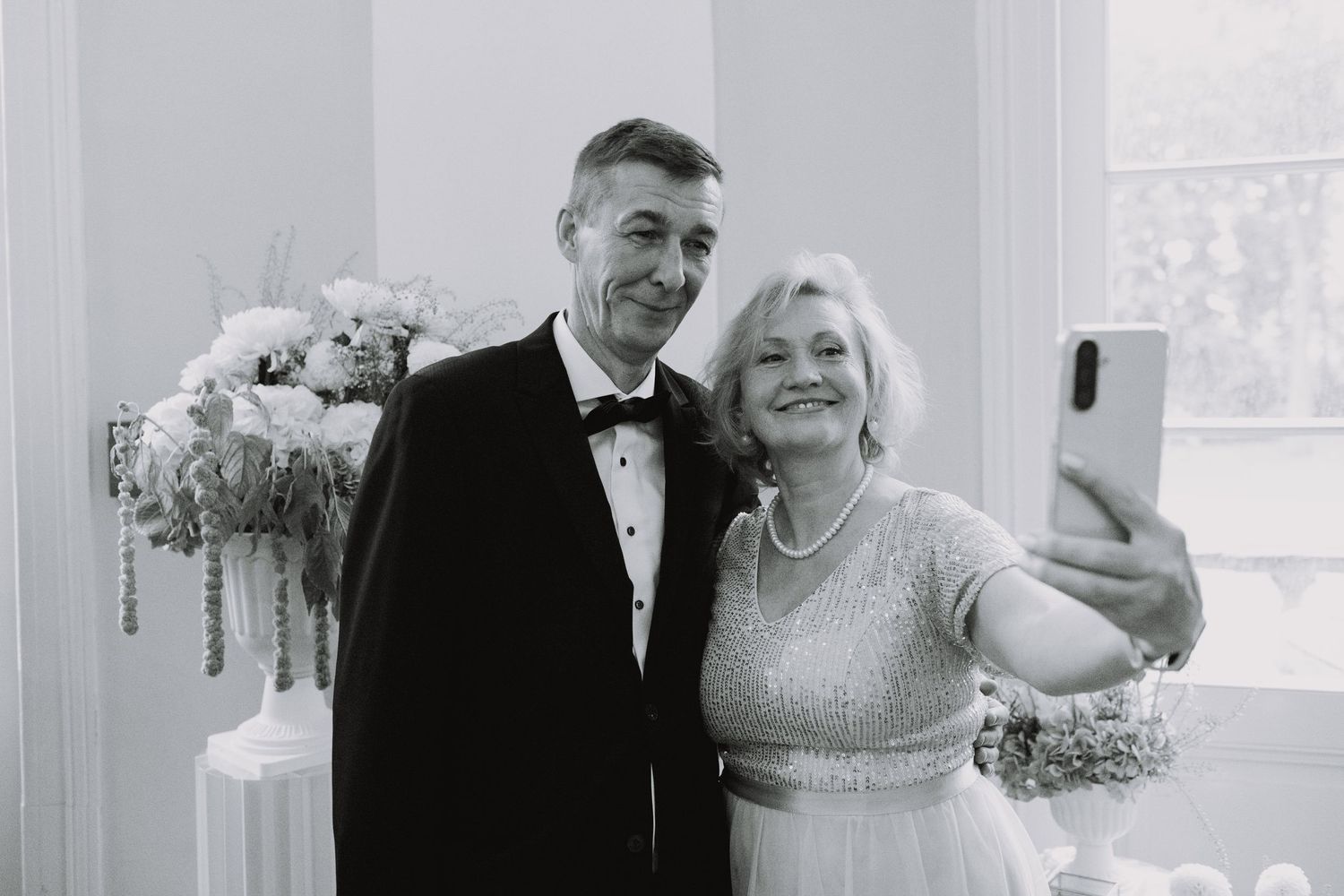 Emotional wedding celebration moments captured in a bright indoor venue.