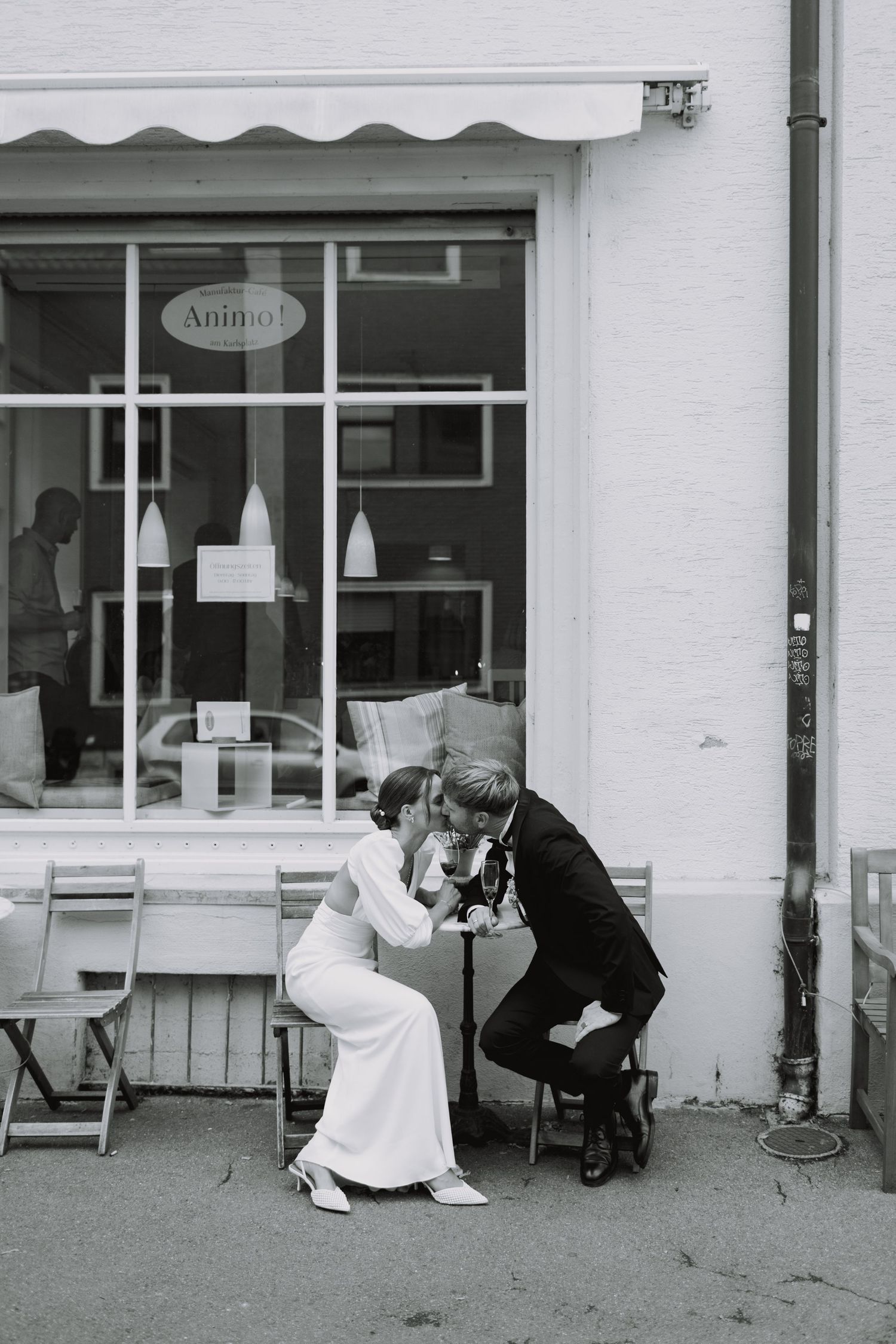 Playful wedding photo sequence outside a white storefront.