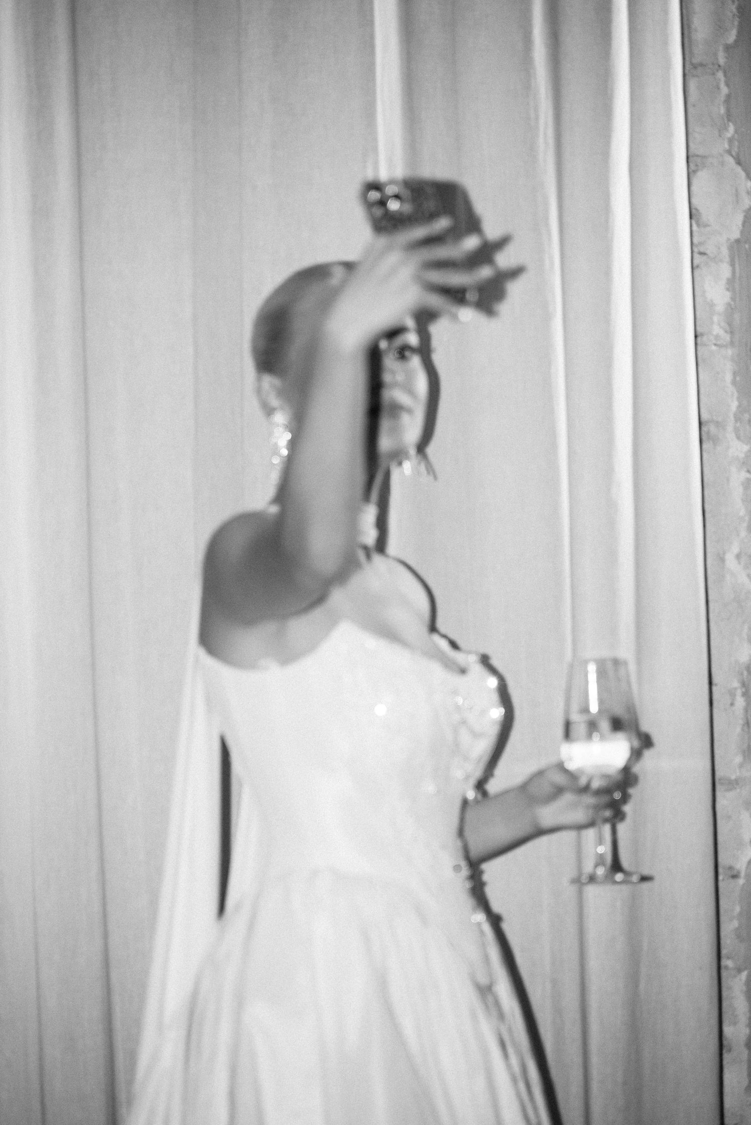 Bride holding a camera during an intimate wedding moment