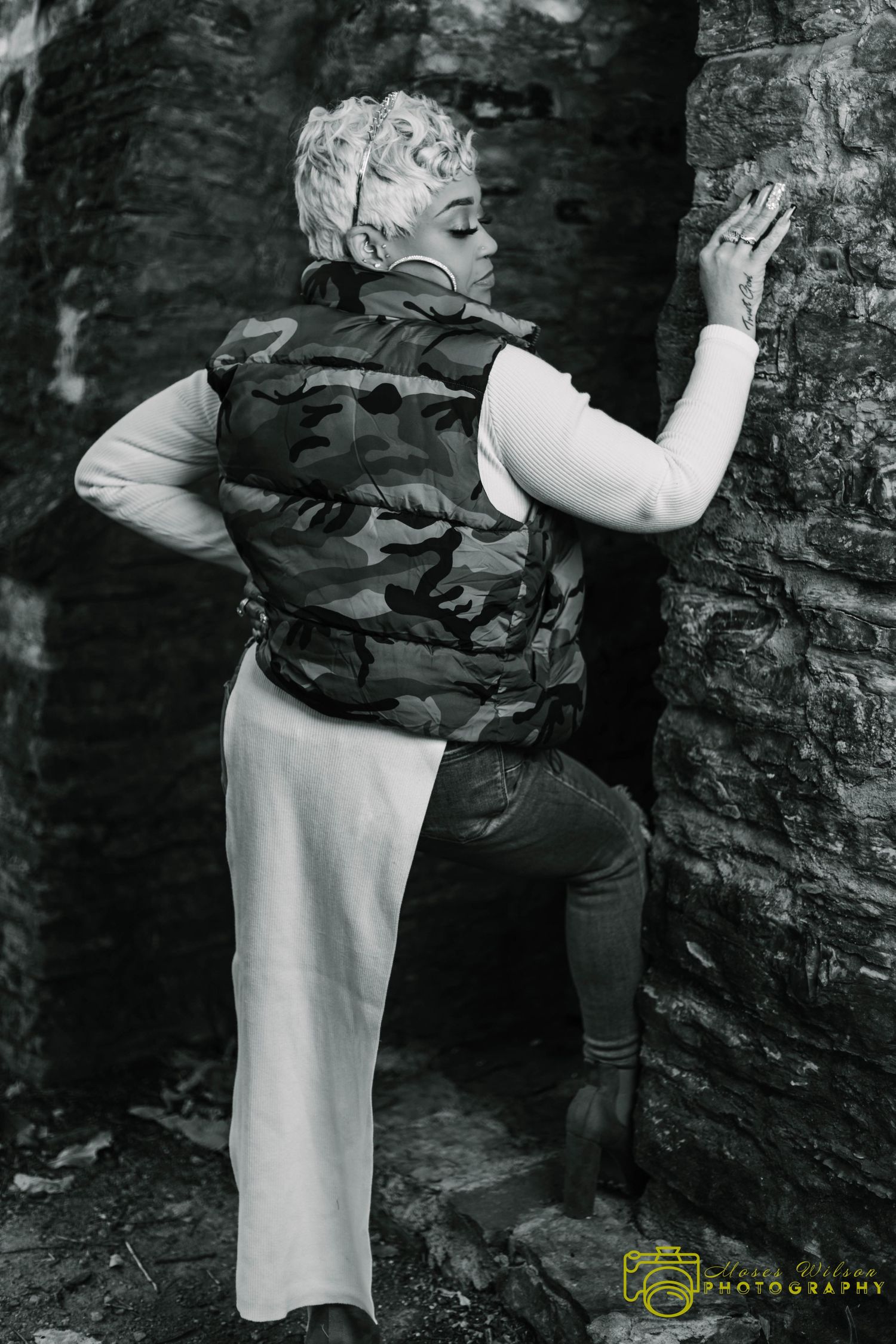 A series of black and white photos showing climbers scaling a rocky wall with climbing gear.
