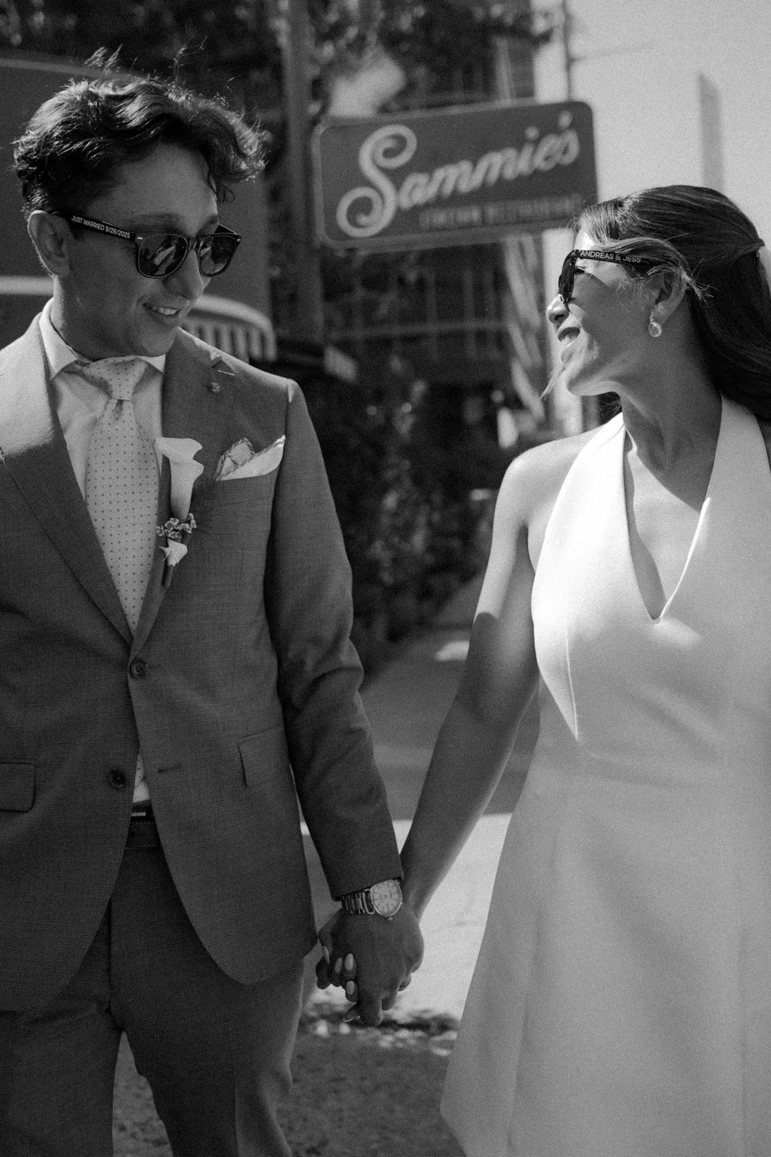 A black and white photo series showing a couple walking together, with the woman in a white dress and man in dark suit. austin downtown