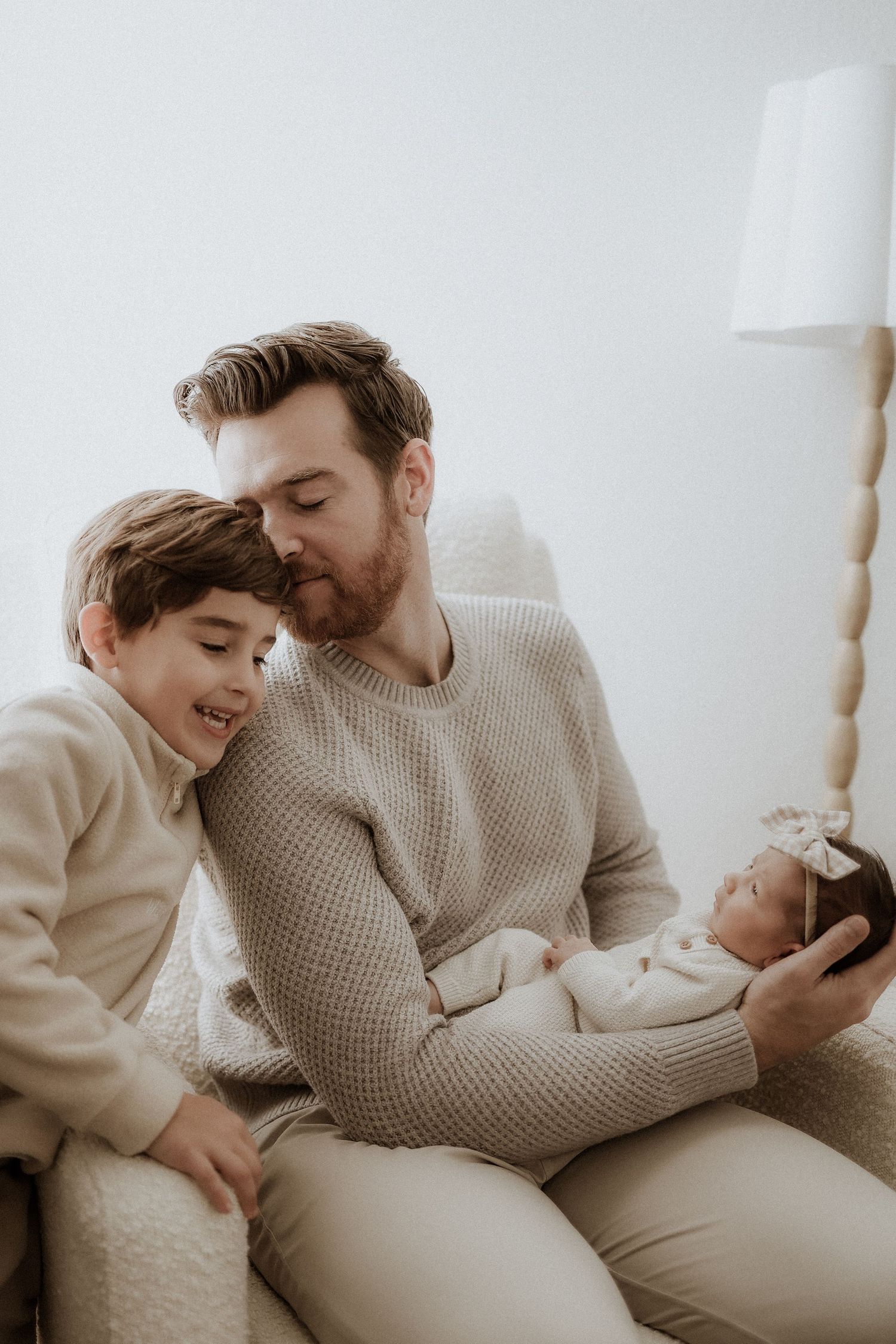 lifestyle newborn photography, dad holding baby and big brother