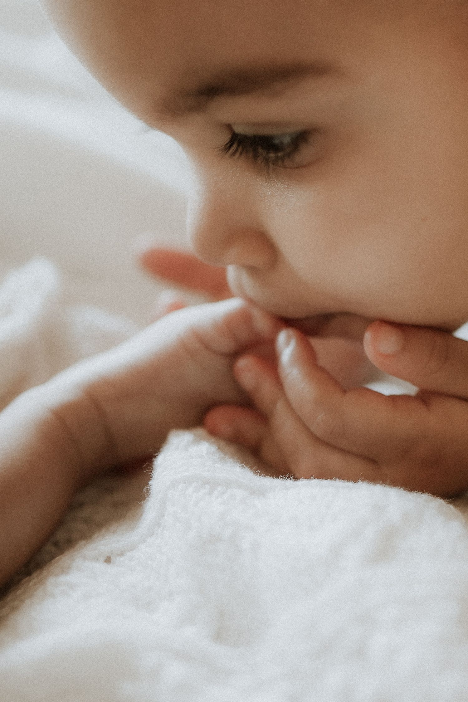 big sister kissing baby brother foot, detail, lifestyle newborn photography