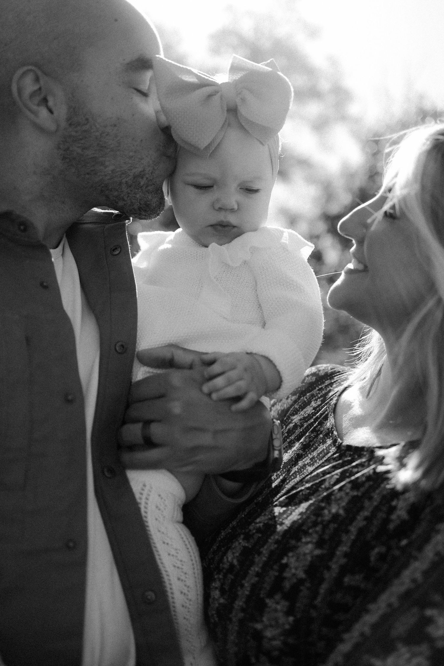family, black and white, portrait, kissing, outdoors