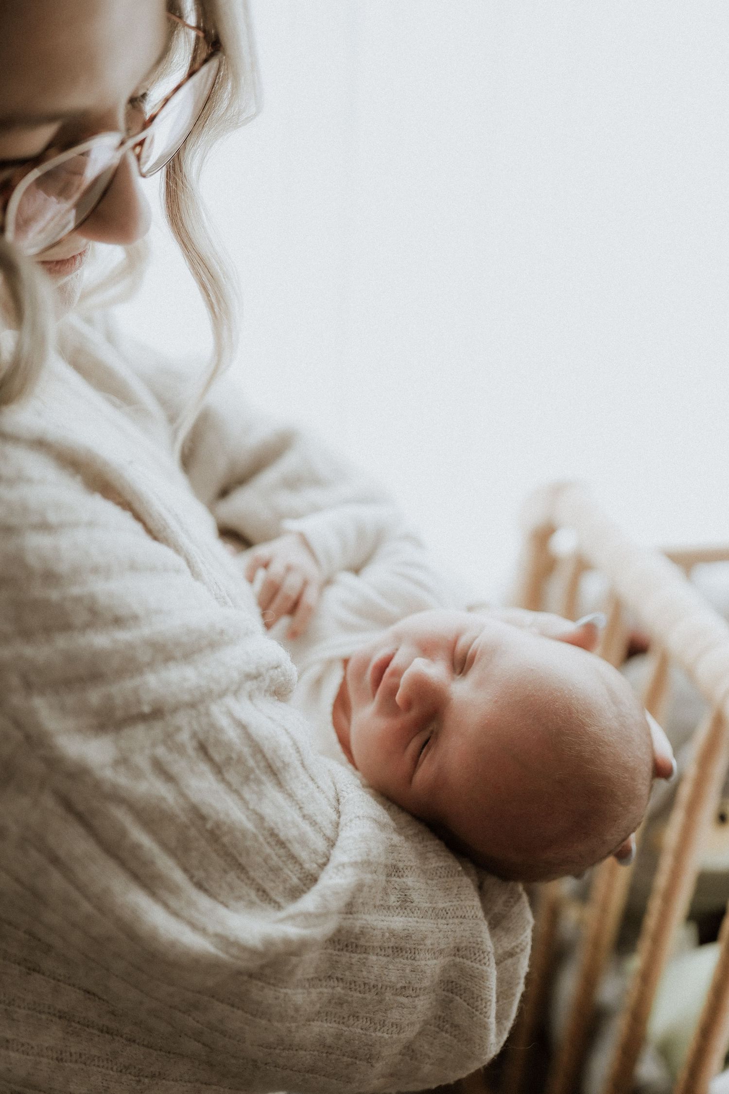 newborn baby held by mom, lifestyle newborn photograph