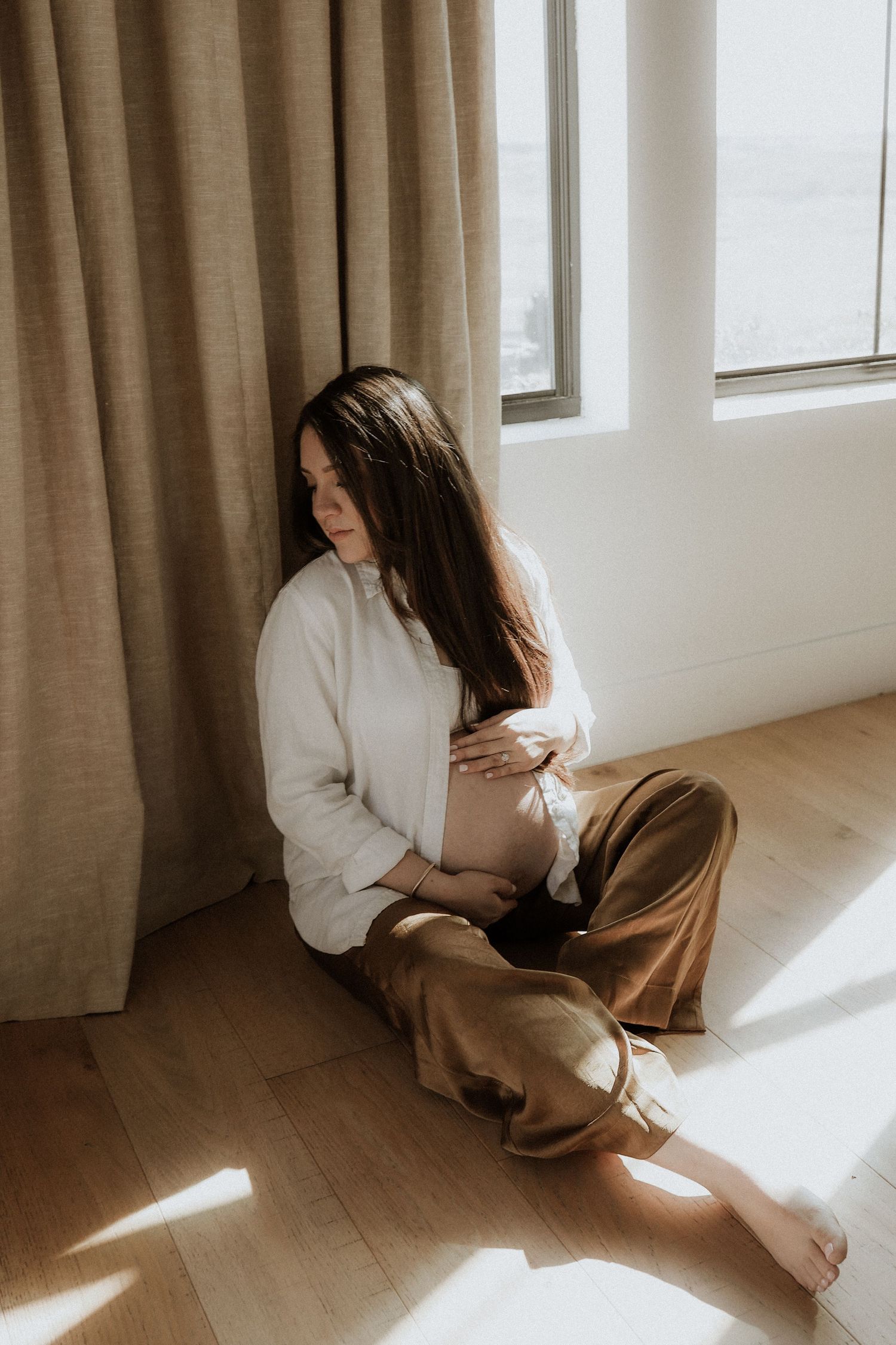 in-home maternity photograph, mom to be portrait, by the window, aesthetic