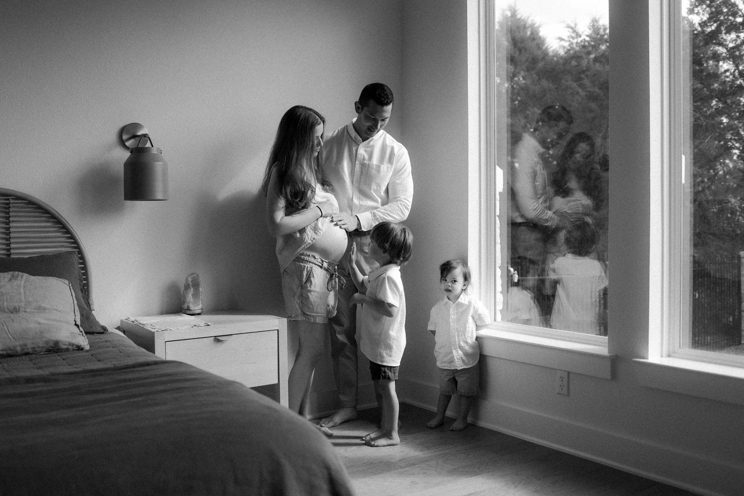 black and white family photoshoot in-home baby bump, mom to be