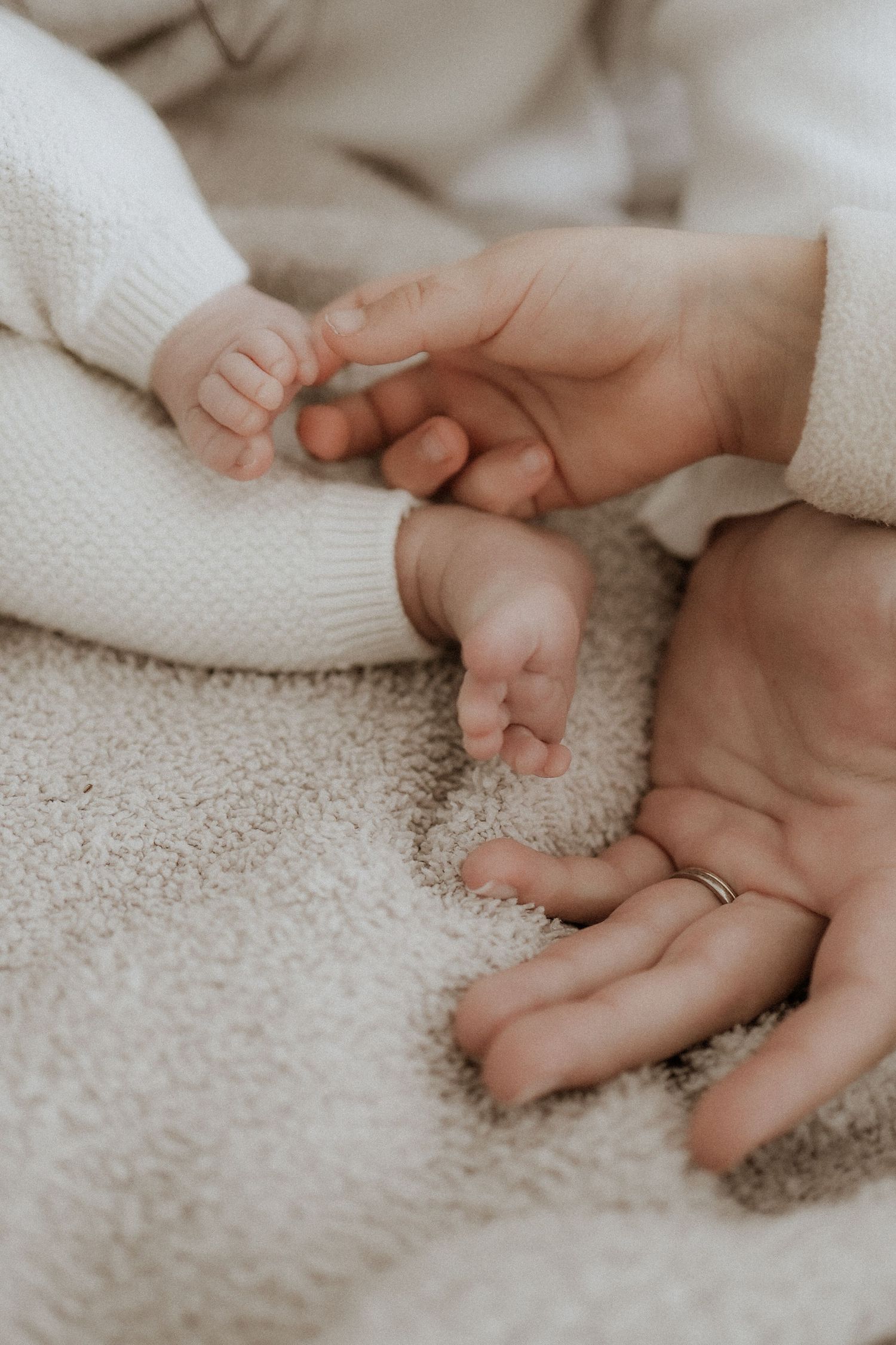 details, hand and baby feet