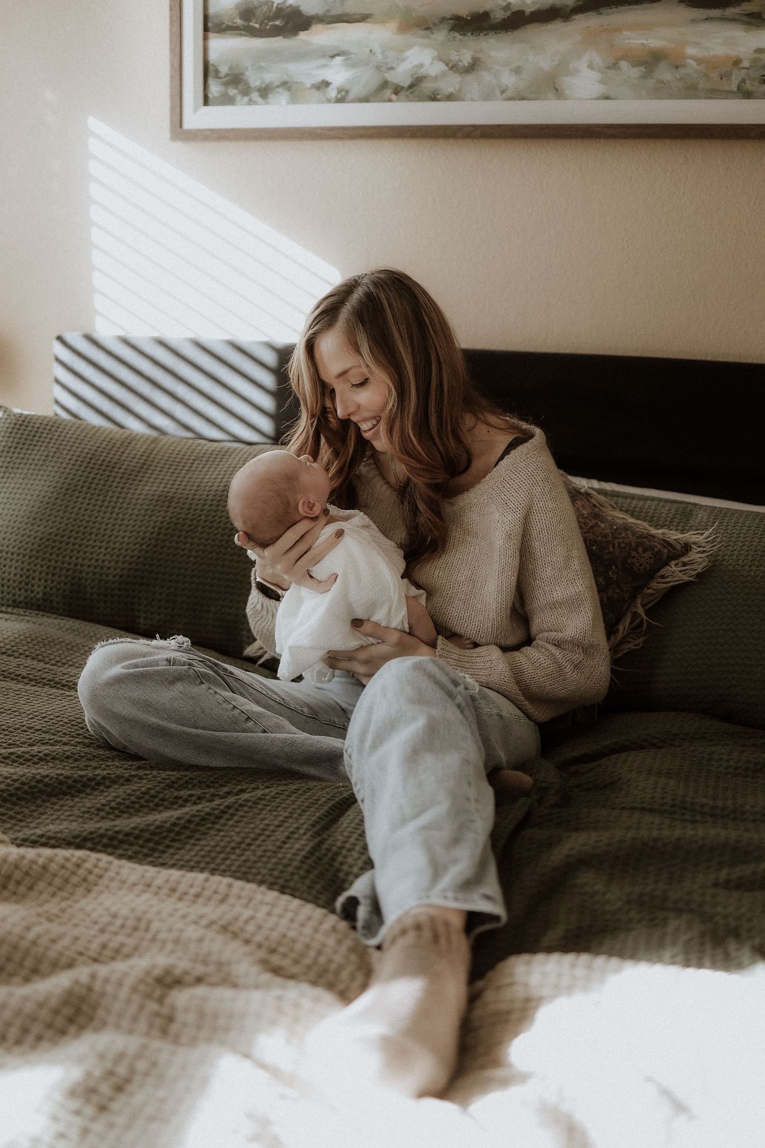 newborn portrait mom and baby on the bed