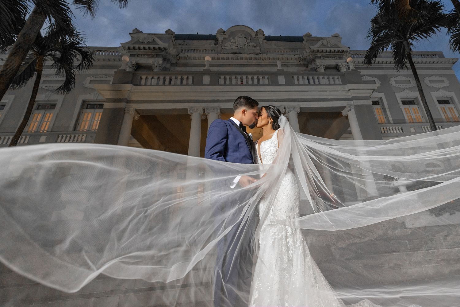 Bride and groom kiss dramatic veil Antiguo Casino de Puerto Rico — wedding photographer Raymond Vega