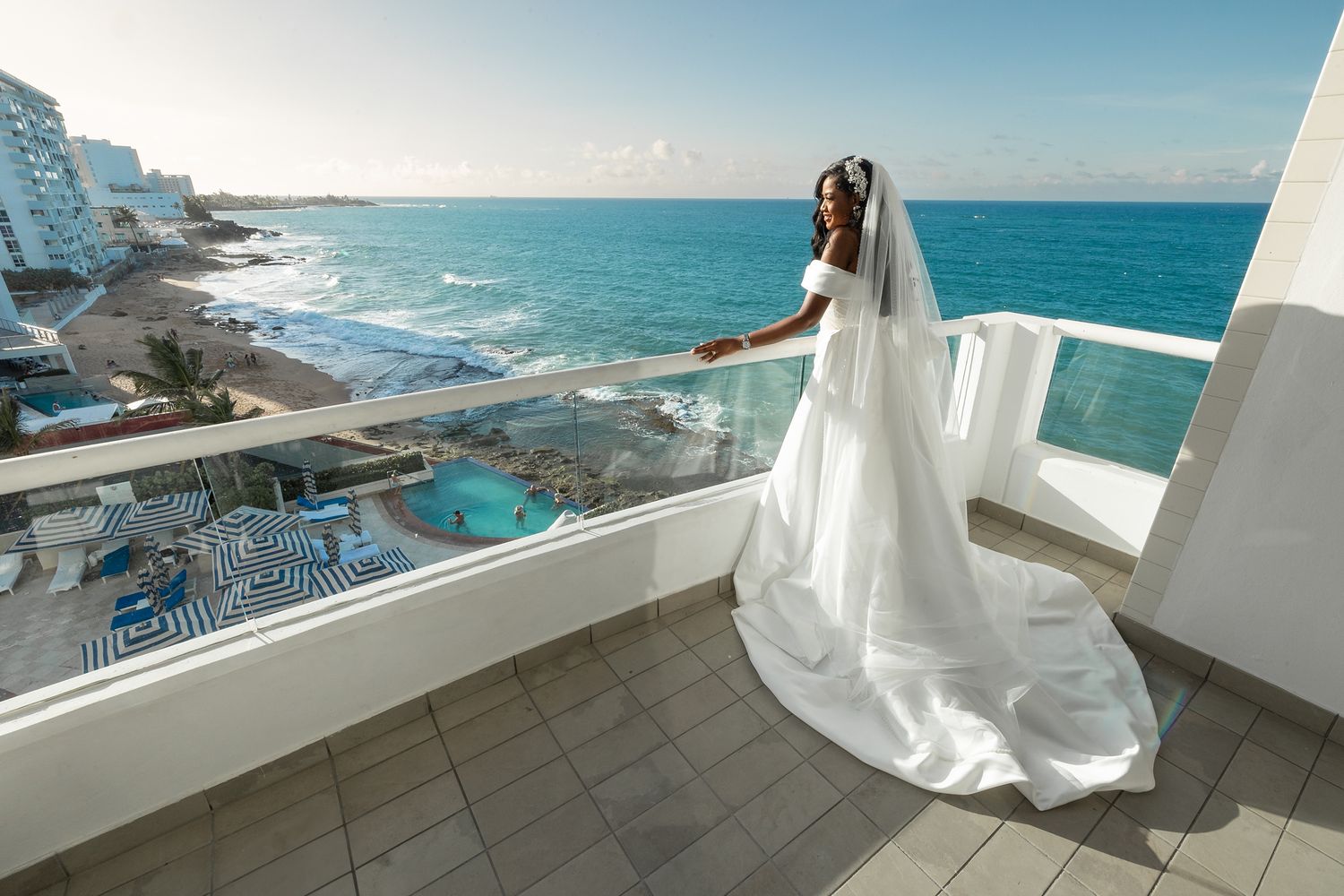 Bride on oceanfront terrace at Condado Vanderbilt Hotel Condado Puerto Rico — destination wedding photographer Raymond Vega