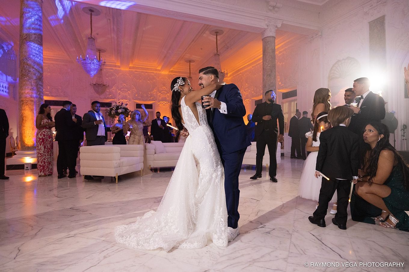 Bride and groom share first dance at elegant wedding reception with marble floors and warm uplighting.Antiguo Casino Puerto Rico wedding
