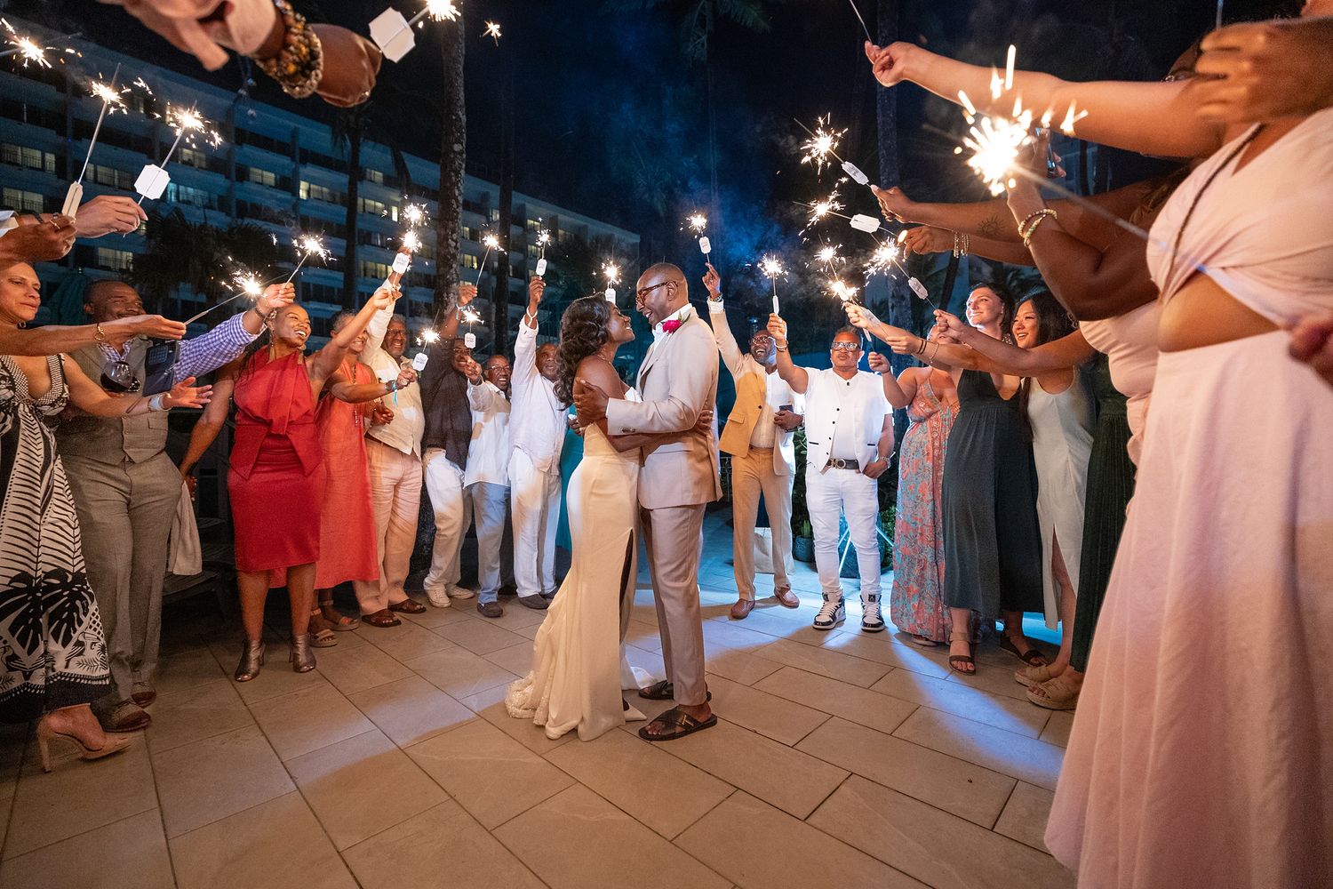 Wedding guests holding sparklers during a celebration at Marriott Renaissance San Juan, Puerto Rico — Raymond Vega Photography + Cinema