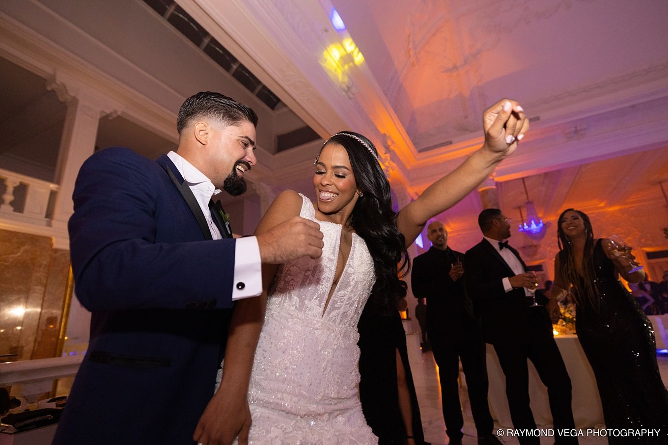 Bride and groom dancing joyfully at wedding reception in elegant ballroom venue.Antiguo Casino Puerto Rico wedding
