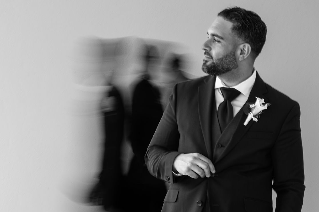 Groom in tuxedo candid black and white portrait — destination wedding photographer Puerto Rico Raymond Vega