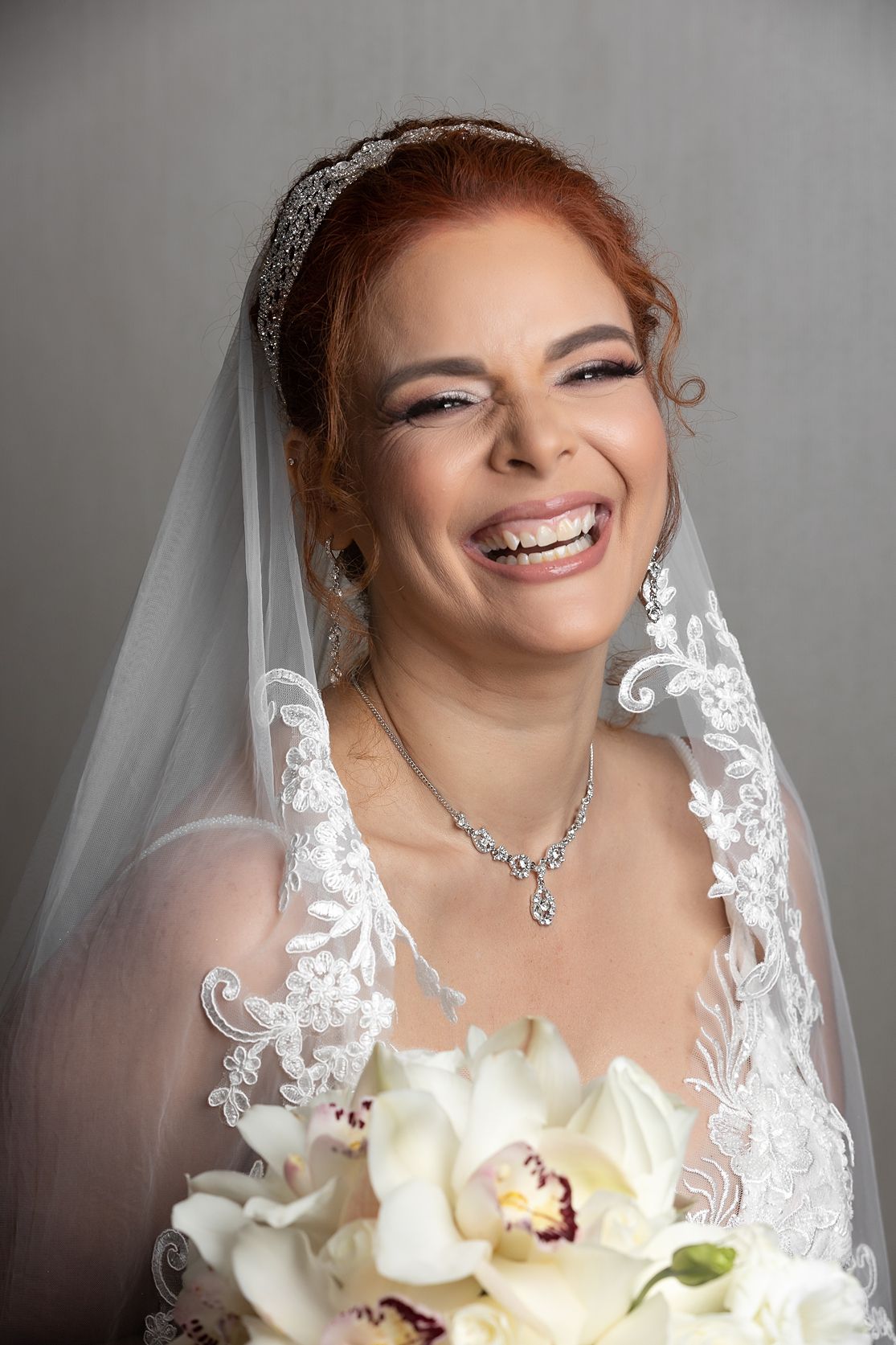Elegant smiling bride portrait with veil and flowers — destination wedding Puerto Rico Raymond Vega