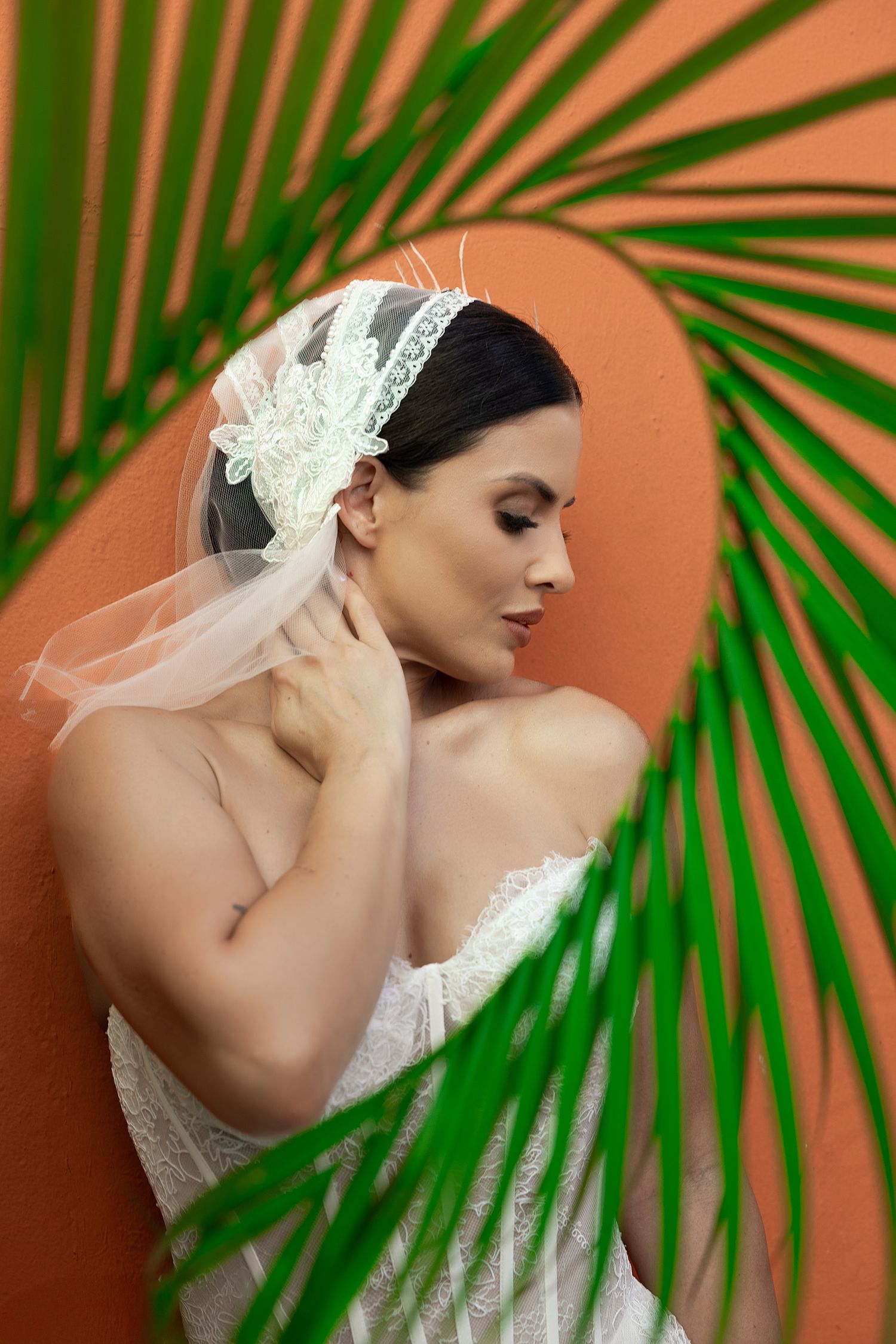 Creative tropical bridal portrait with palm leaf — Puerto Rico wedding cinematographer and photographer Raymond Vega