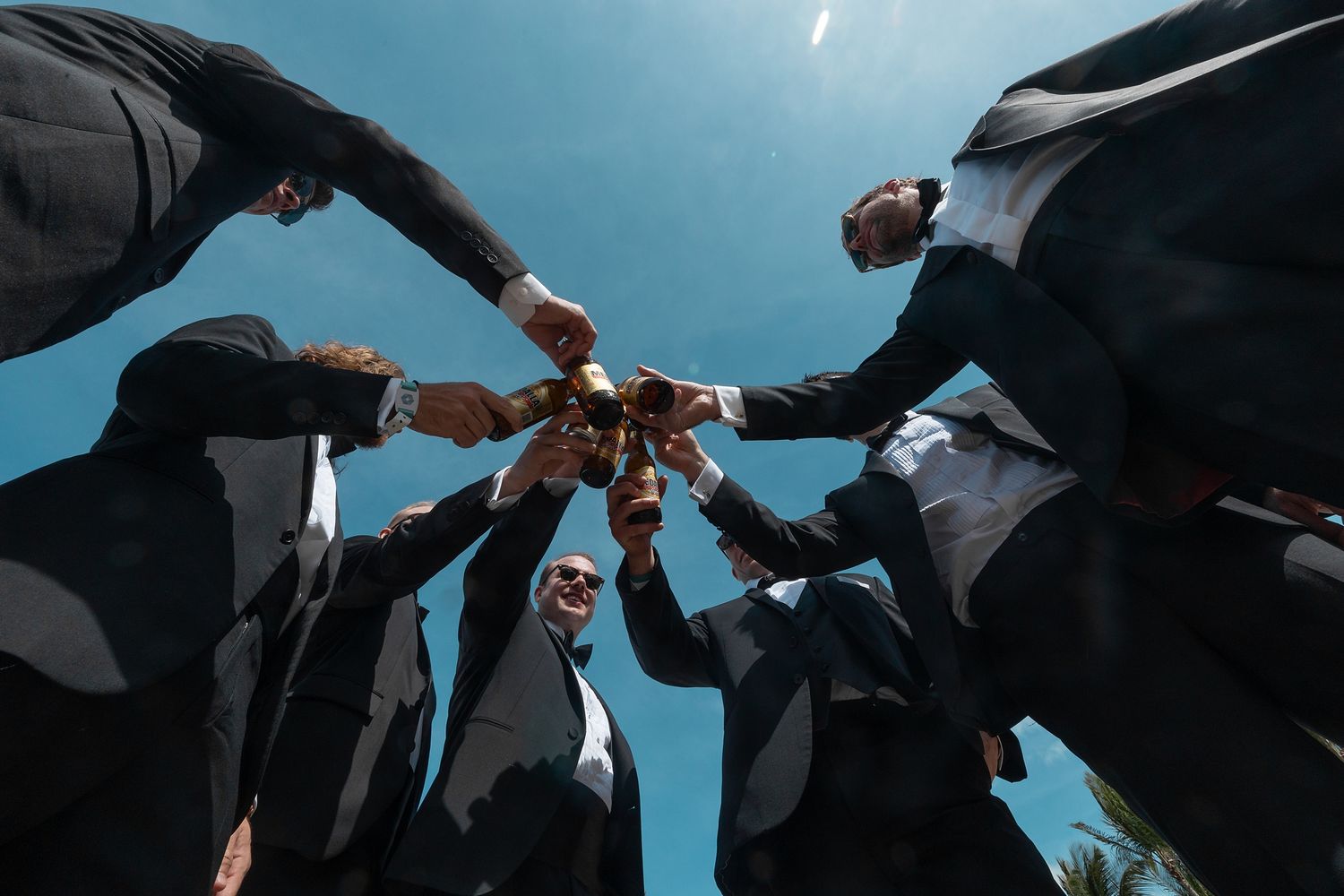 Wedding party celebrating outdoors under dramatic sky — award-winning destination wedding photographer Puerto Rico Raymond Vega