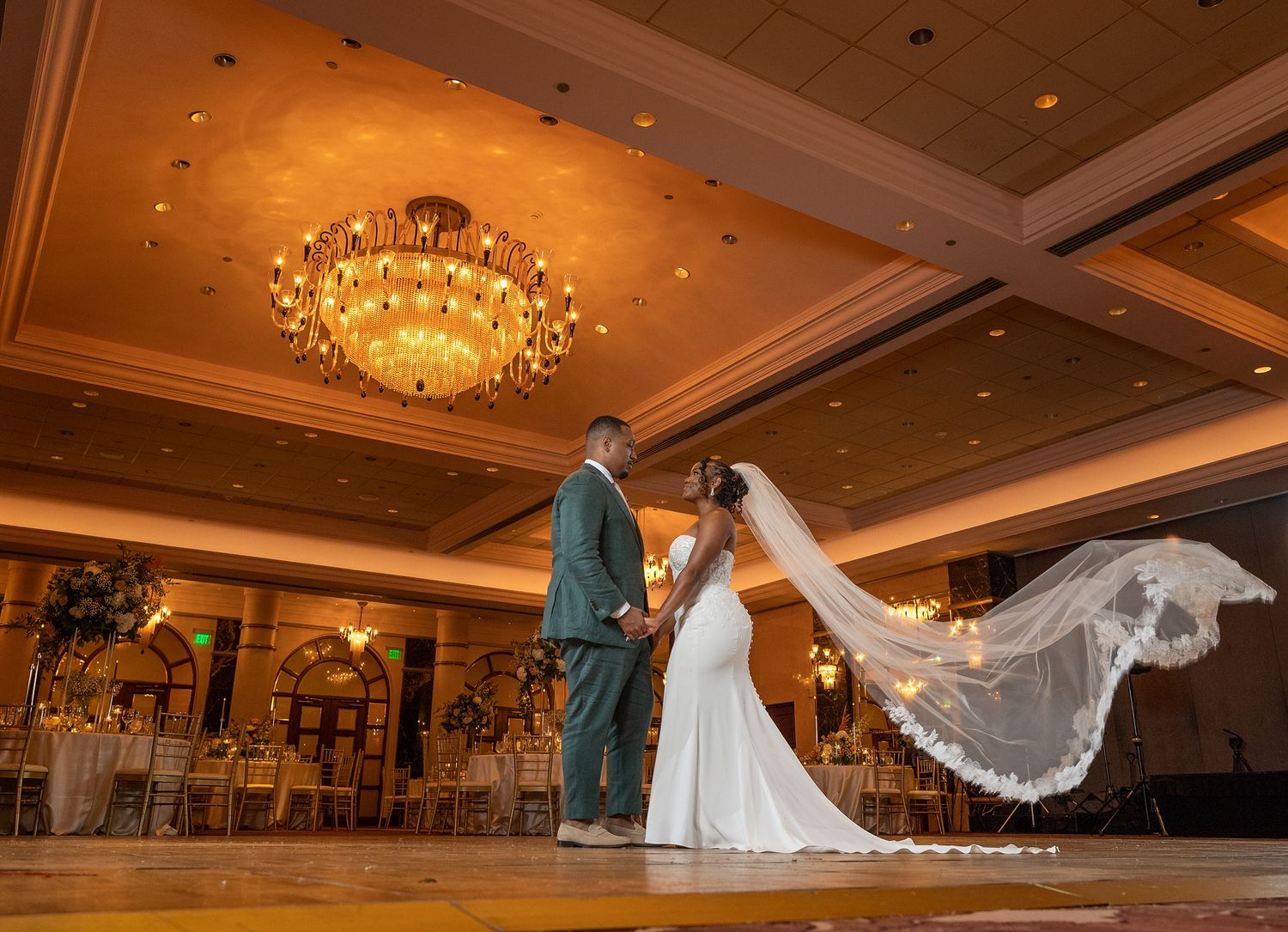 Bride and groom sharing their first dance inside the grand ballroom of The Vanderbilt Hotel San Juan — luxury wedding photography by Raymond