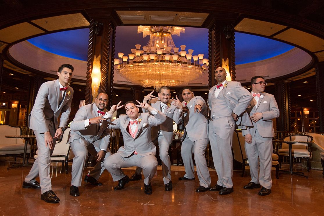 Groomsmen celebrating under crystal chandelier Fairmont El San Juan Hotel Puerto Rico — Raymond Vega