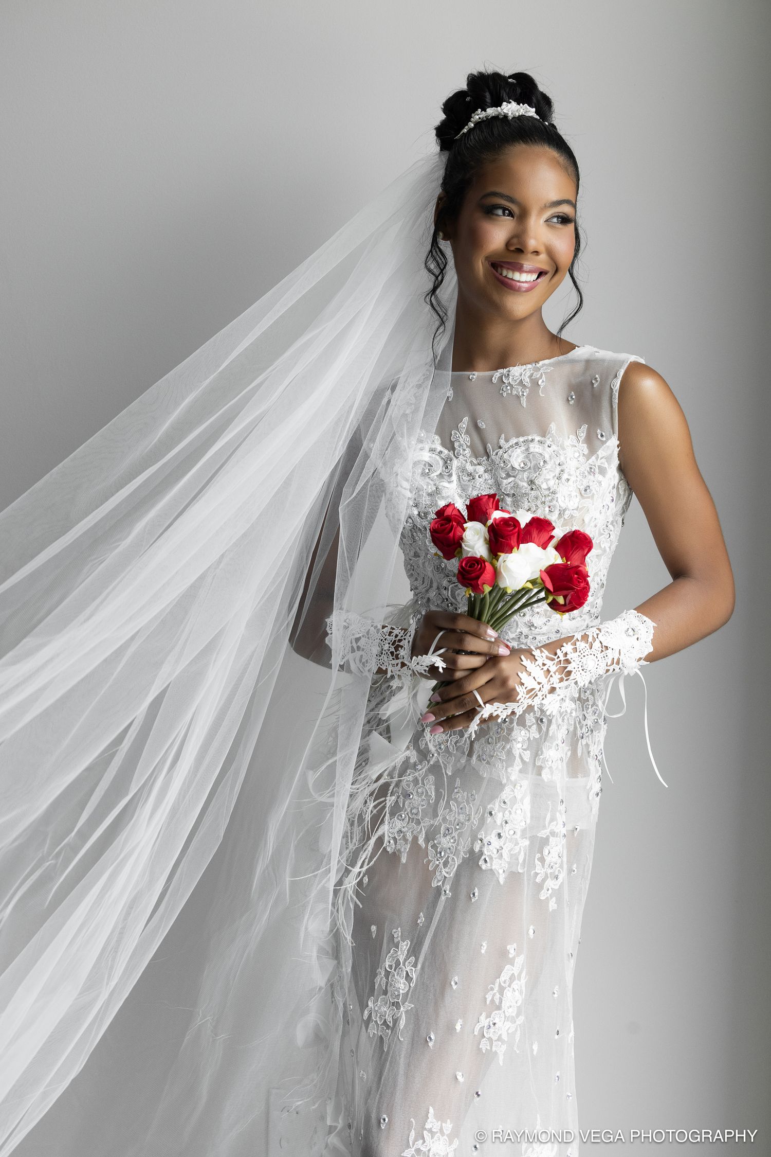 Elegant minimalist bride portrait with red bouquet and long veil — wedding photographer Puerto Rico Raymond Vega