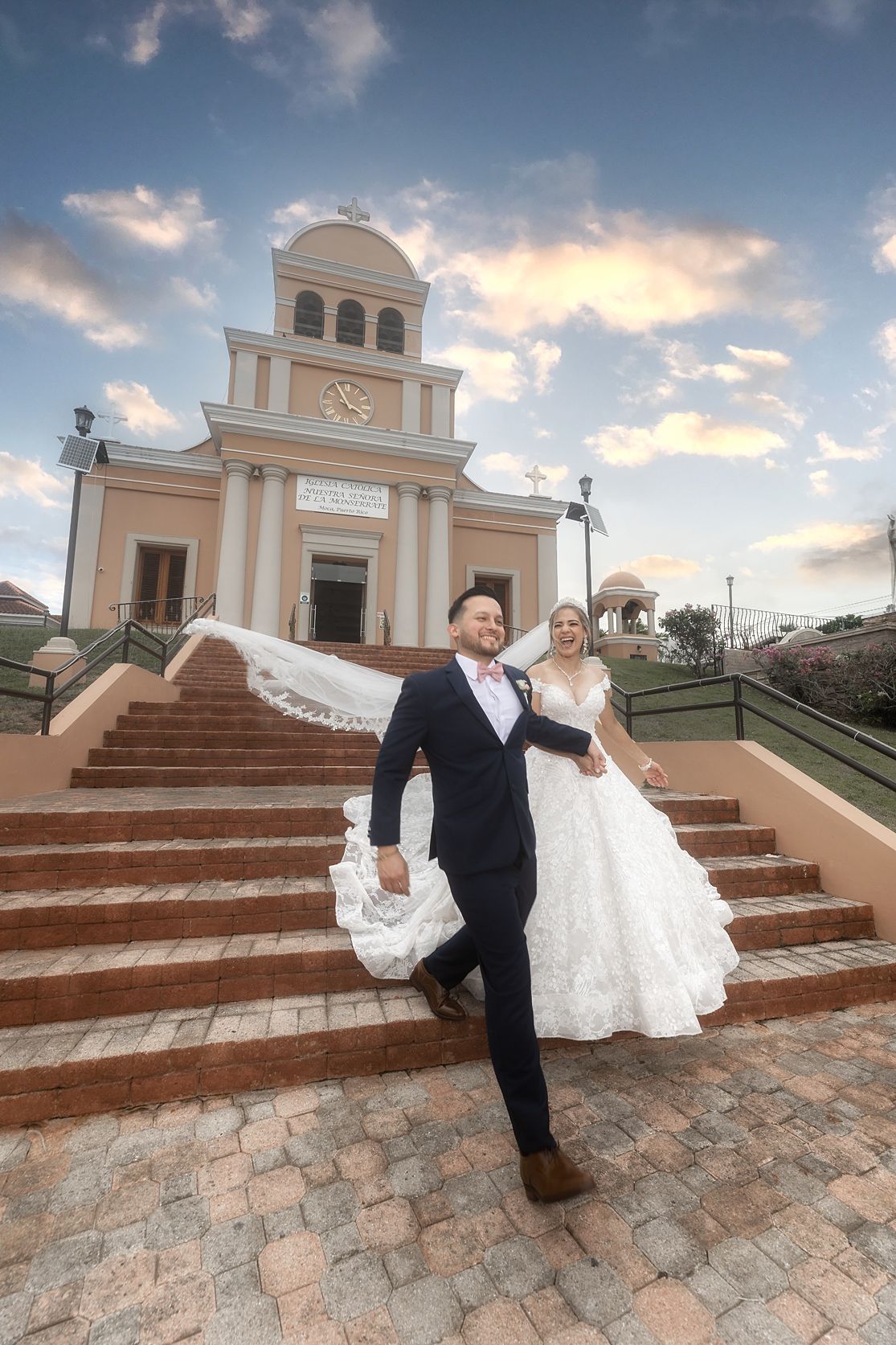 Bride and groom on steps of colonial church Puerto Rico — destination wedding photographer Raymond Vega