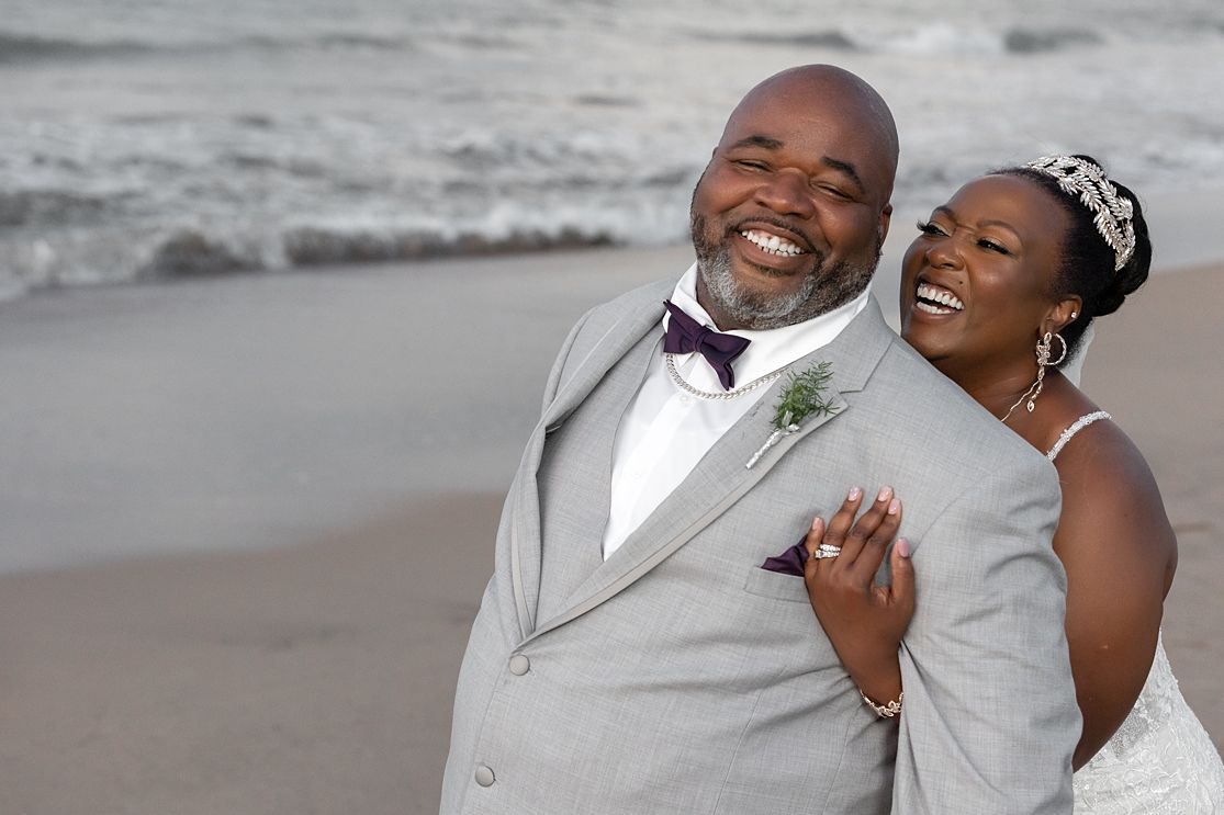 Happy bride and groom laughing on beach — destination wedding photography Puerto Rico Raymond Vega