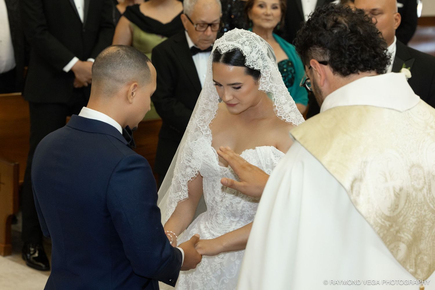 Bride and groom exchange vows at church altar with priest officiating elegant wedding ceremony.