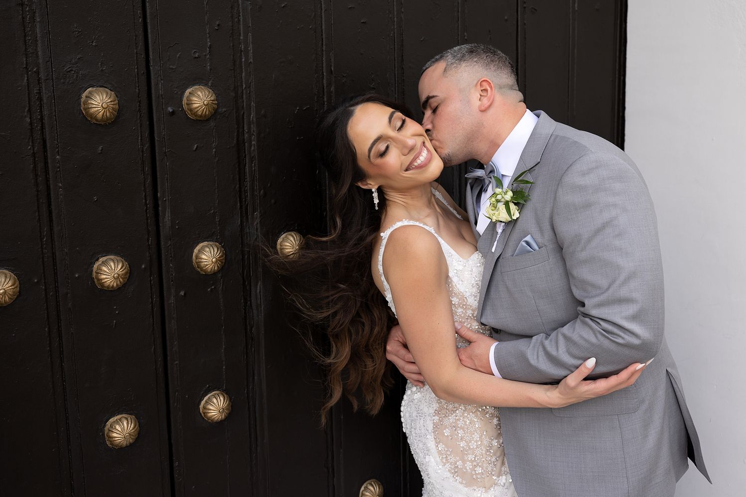 Romantic couple portrait at ornate door Puerto Rico — destination wedding photographer Raymond Vega