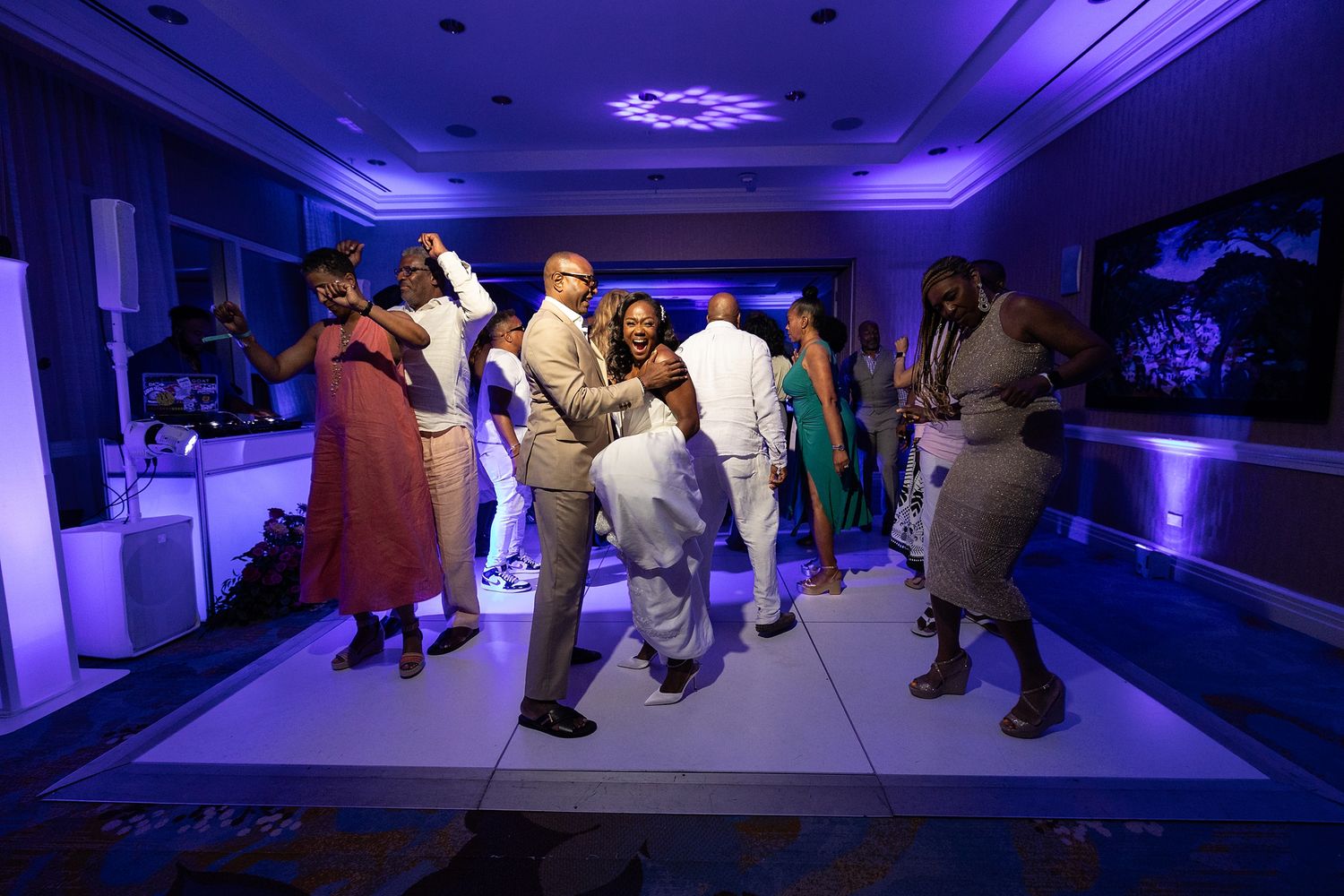Guests dancing under purple lights during a wedding reception party at Marriott Renaissance San Juan, Puerto Rico — Raymond Vega Photography