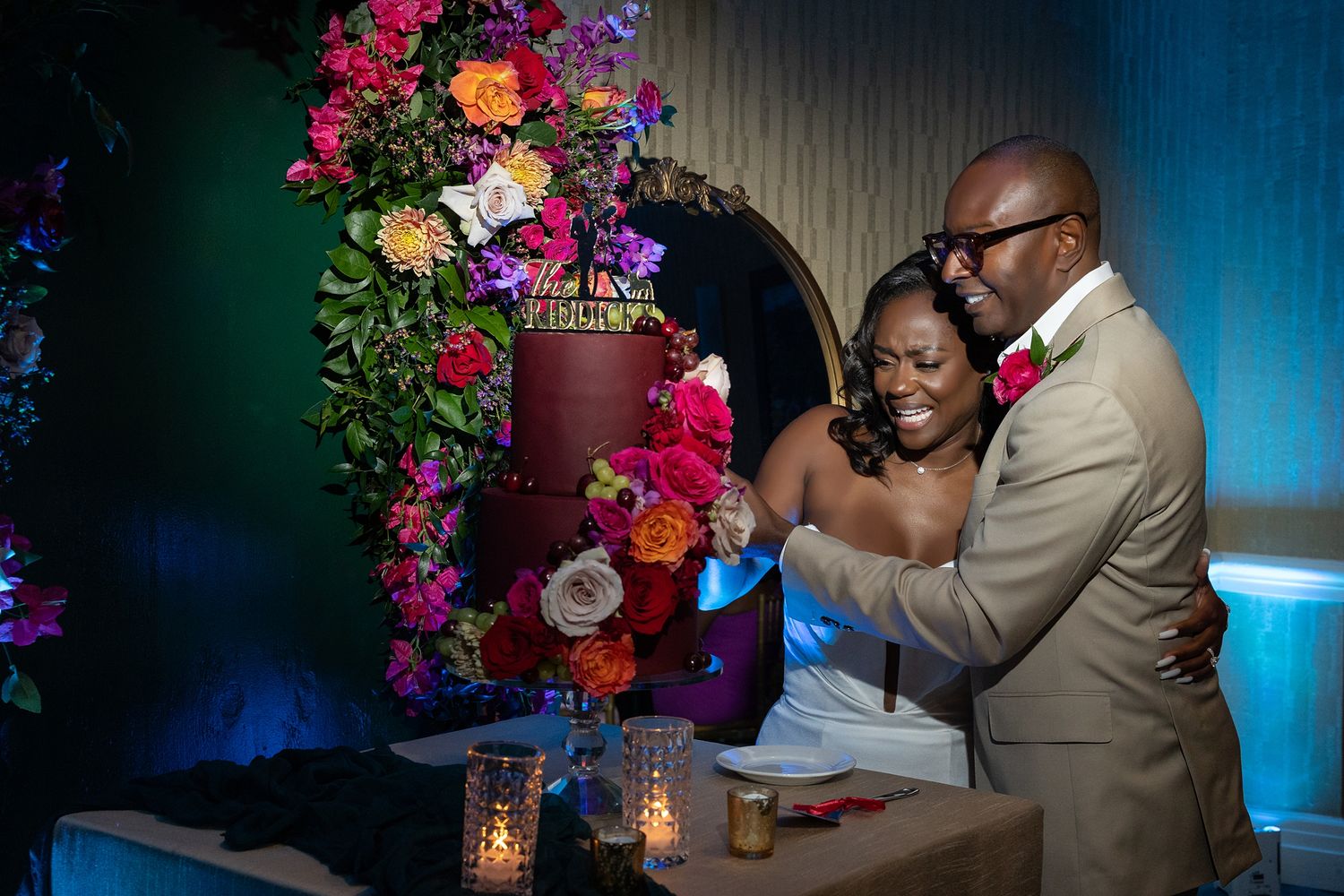 Bride and groom sharing a romantic moment surrounded by a stunning floral arch at their Isla Verde wedding in Puerto Rico — Raymond Vega Pho