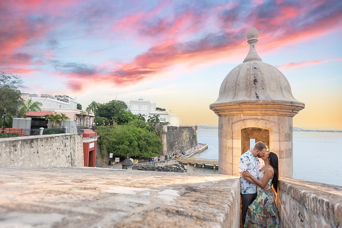 Bride and groom at historic garita with stunning pink sunset Old San Juan Puerto Rico — destination wedding photographer Raymond Vega