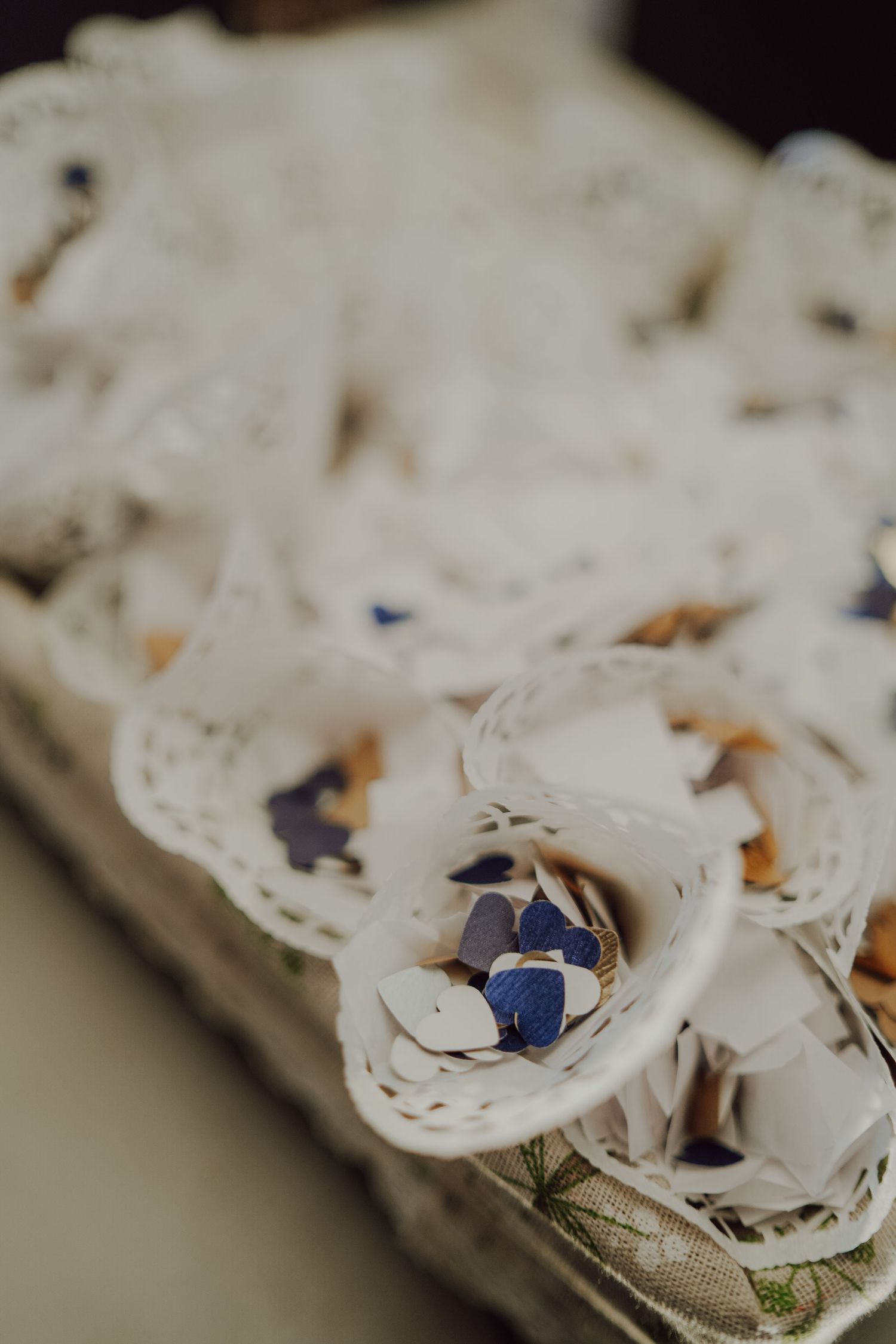 Blue floral petals nestled in delicate white lace create an elegant wedding detail.