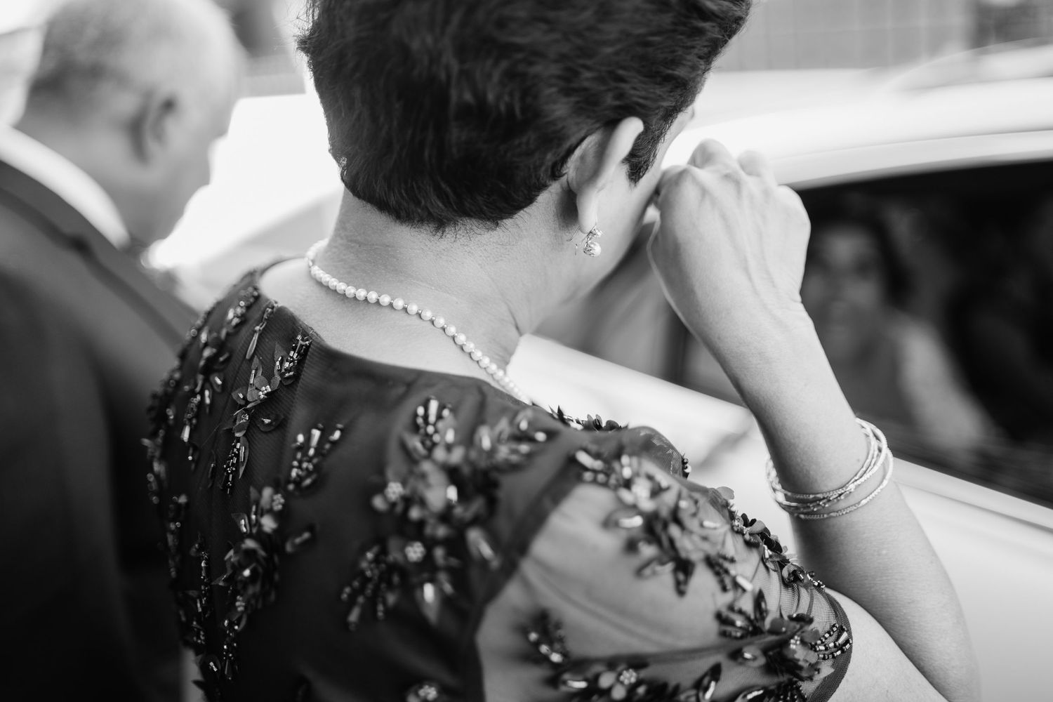 Black and white emotional moment captured during wedding ceremony.