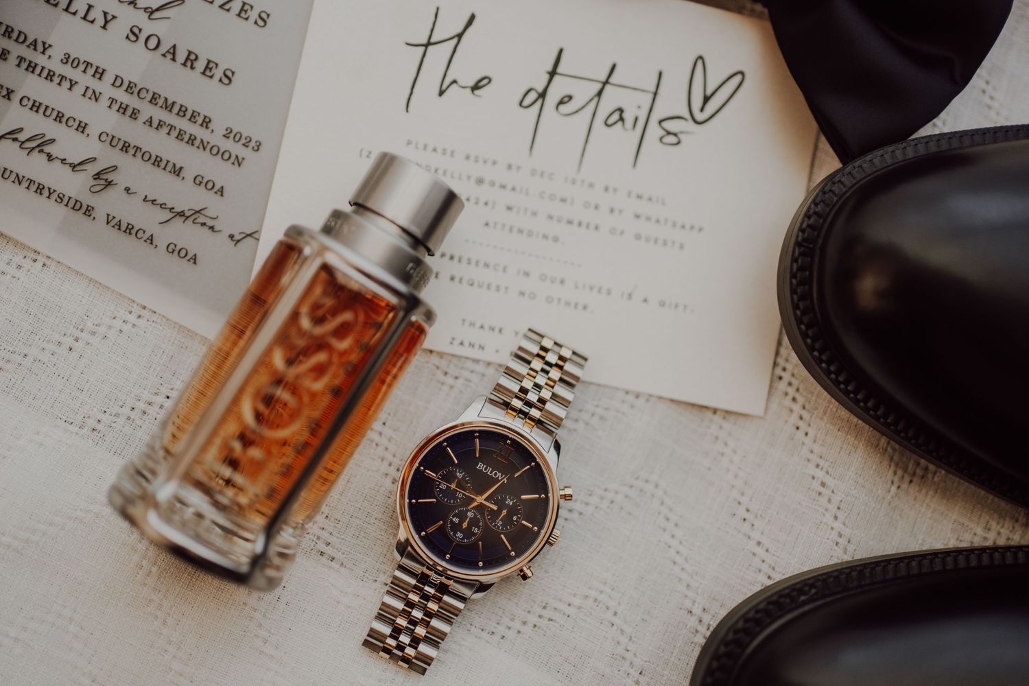 A luxury watch and cologne bottle arranged on a paper with handwritten text.