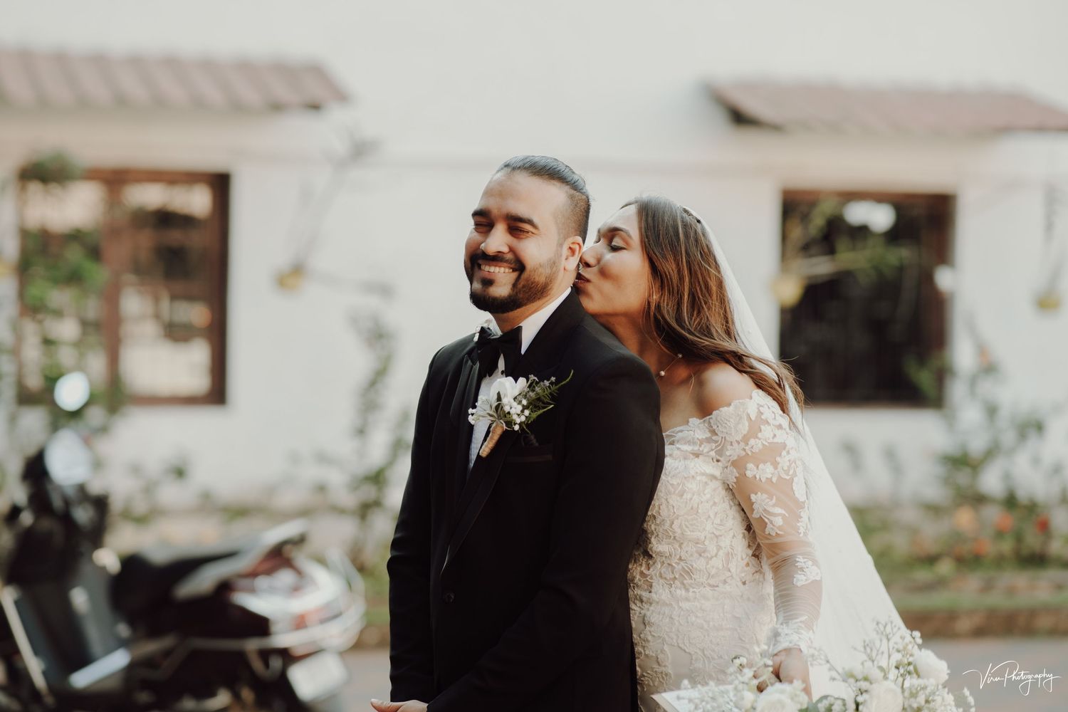 A happy couple shares a candid moment together outdoors during their wedding celebration.