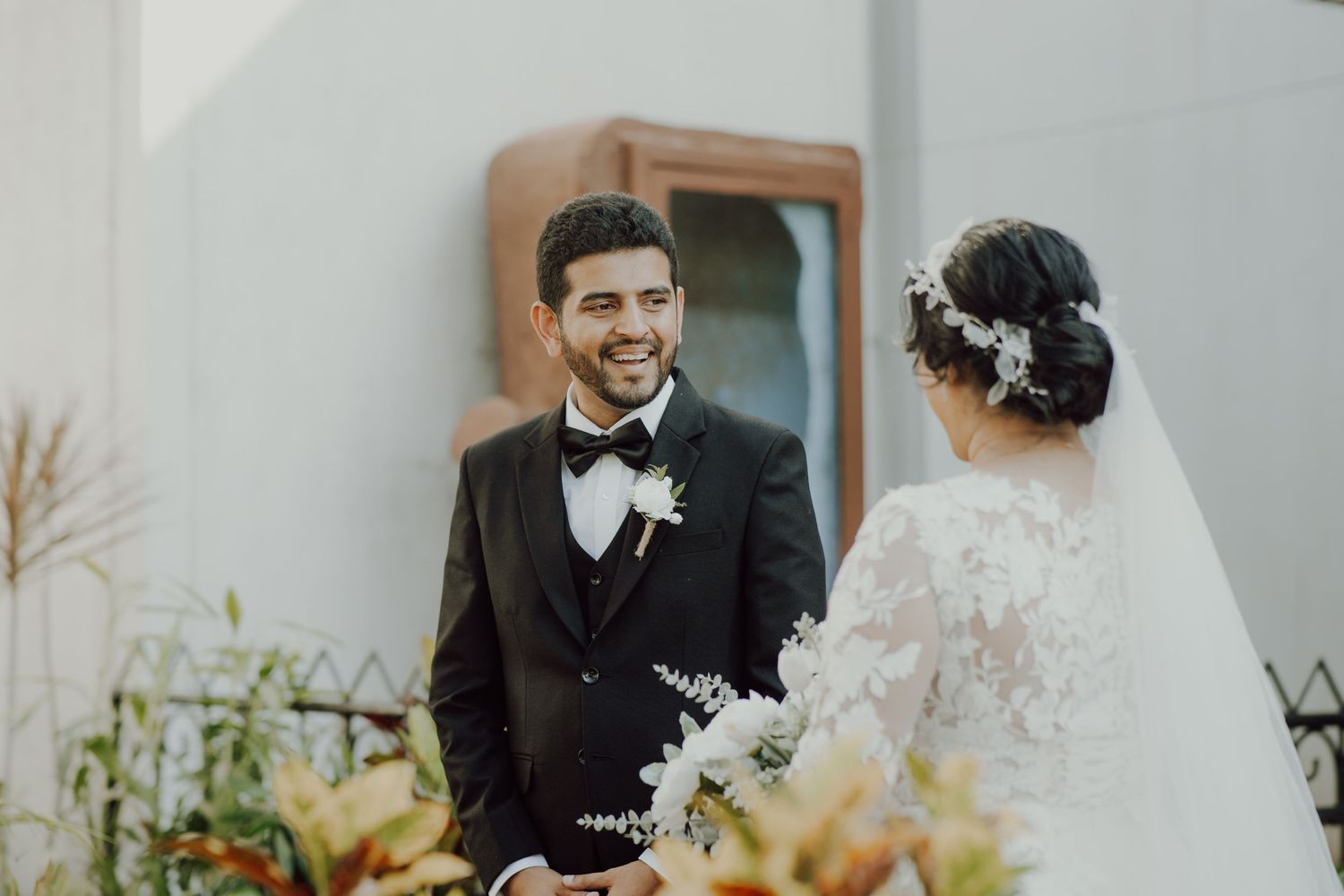 Intimate wedding moment captured in a garden setting with natural light.