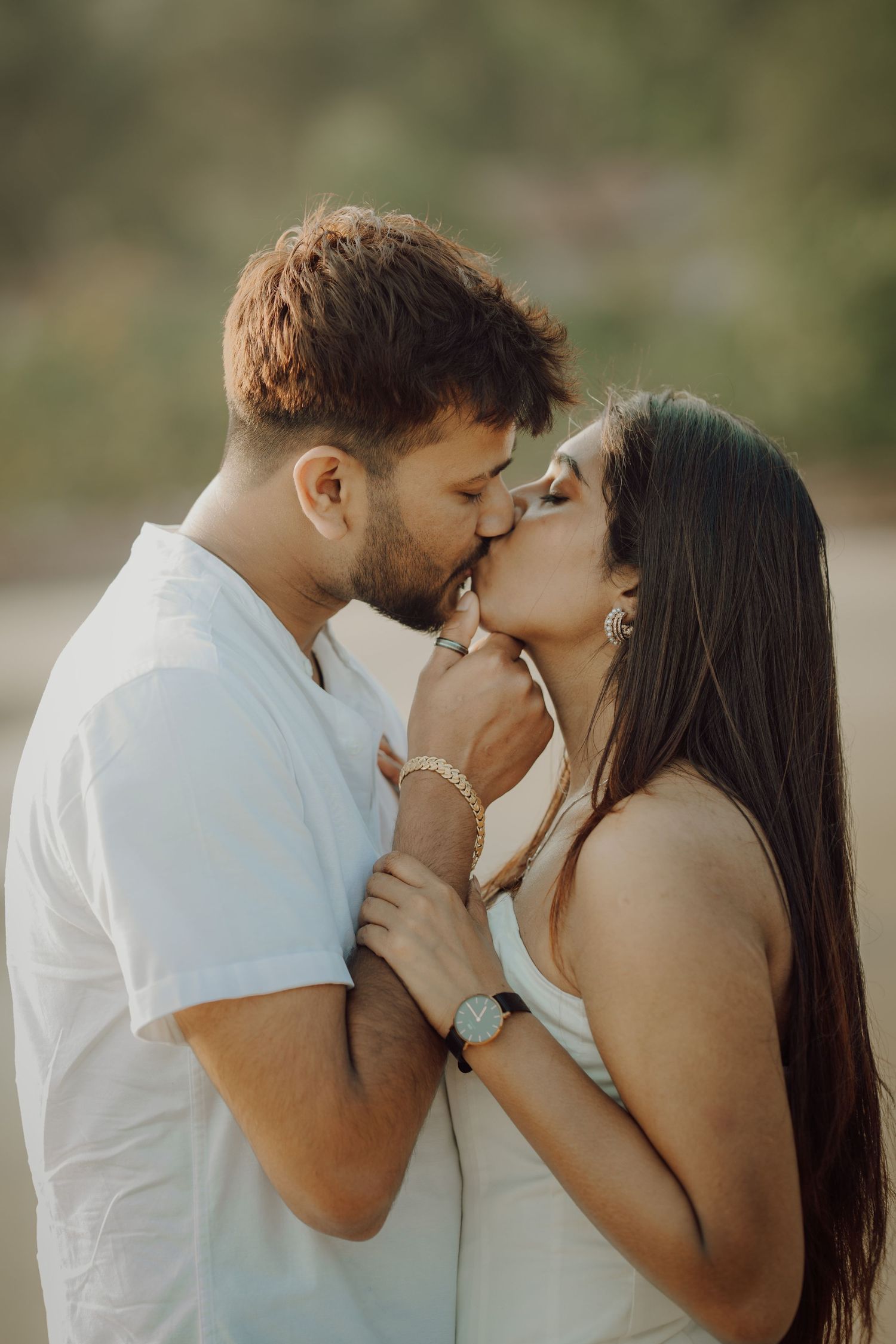 A romantic couple sharing an intimate kiss in a series of progressive outdoor portrait shots in natural lighting.