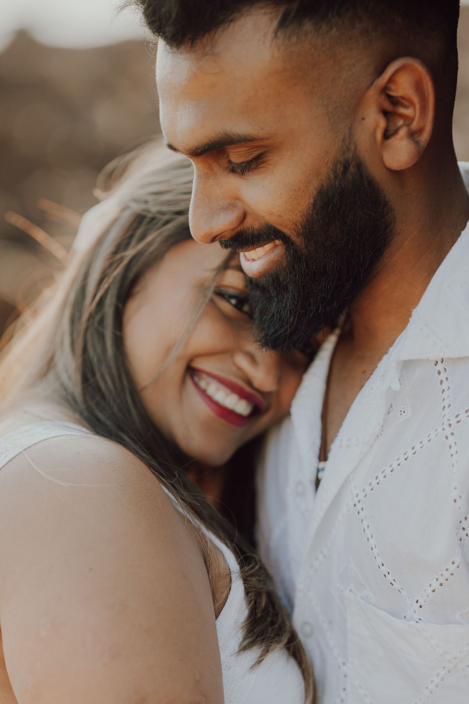 A romantic couple shares tender moments in a series of intimate close-up photos showing affection and laughter.