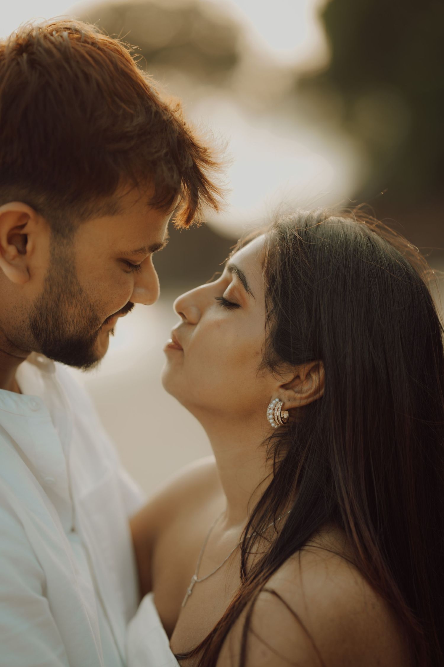 A romantic couple shares intimate moments in a series of warm-toned photographs at sunset.