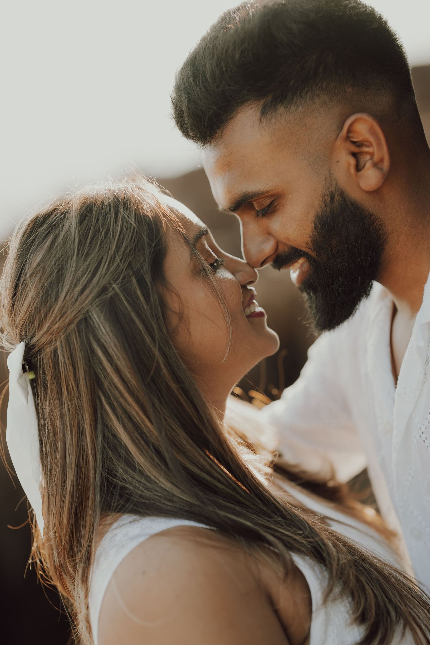 Romantic couple sharing intimate moments in a series of soft-lit close-up profile shots.