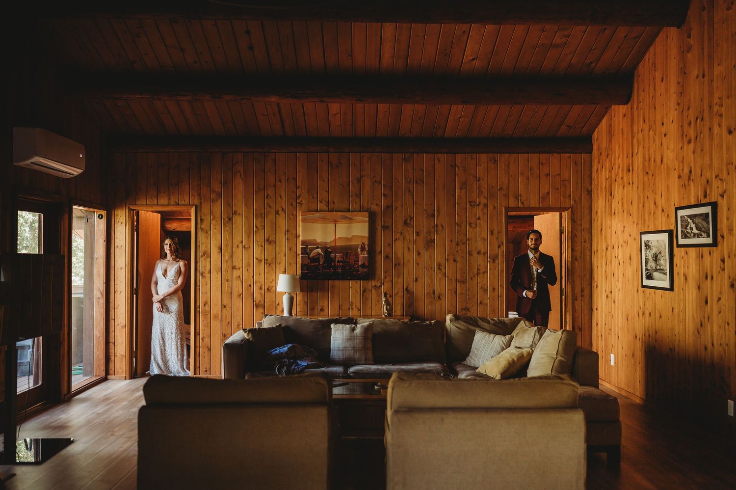Interior view of a rustic cabin with wooden paneled walls and ceiling.