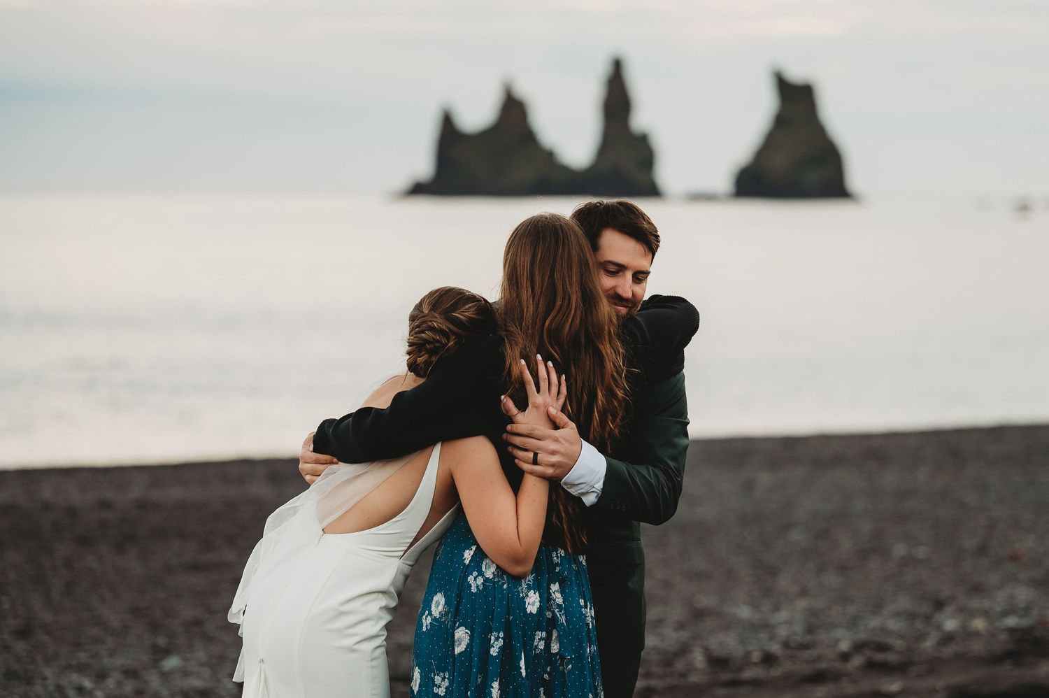 Couple sharing romantic moments on a beach with crashing waves in the background.