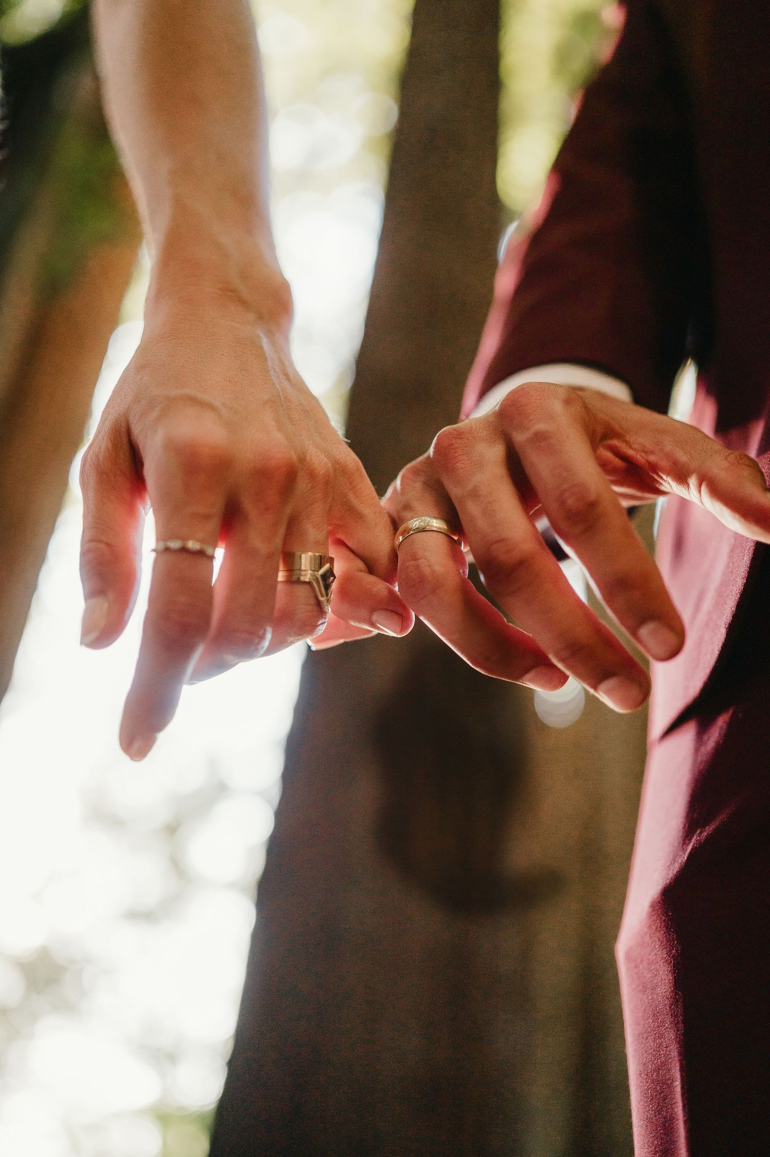 Close-up shots of hands with wedding rings in soft natural light.