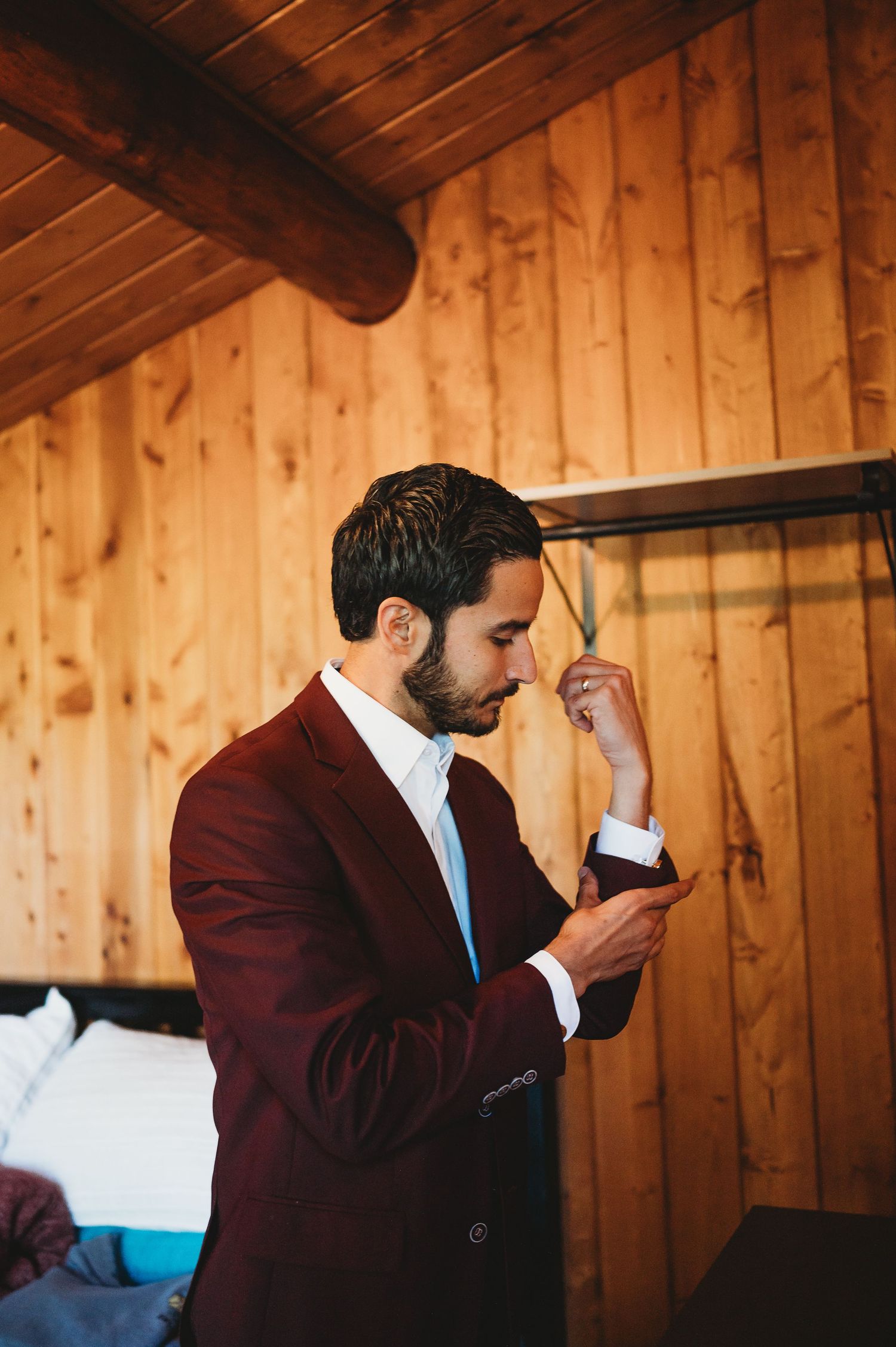 Series of photos showing a person in a burgundy suit getting emotional while looking at a note in a wooden paneled room.